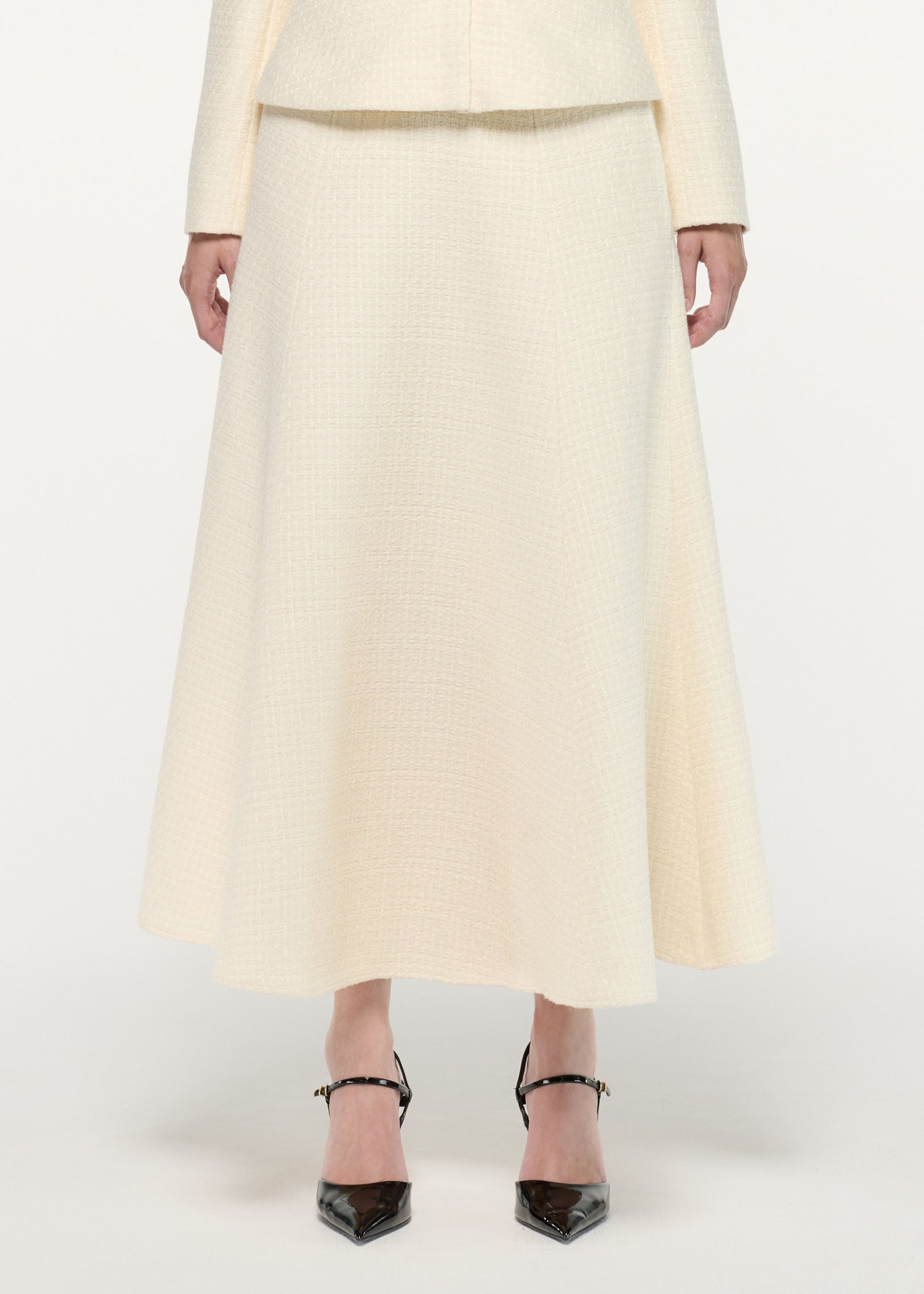 Close up of a model wearing the Boucle Midi Flared Skirt