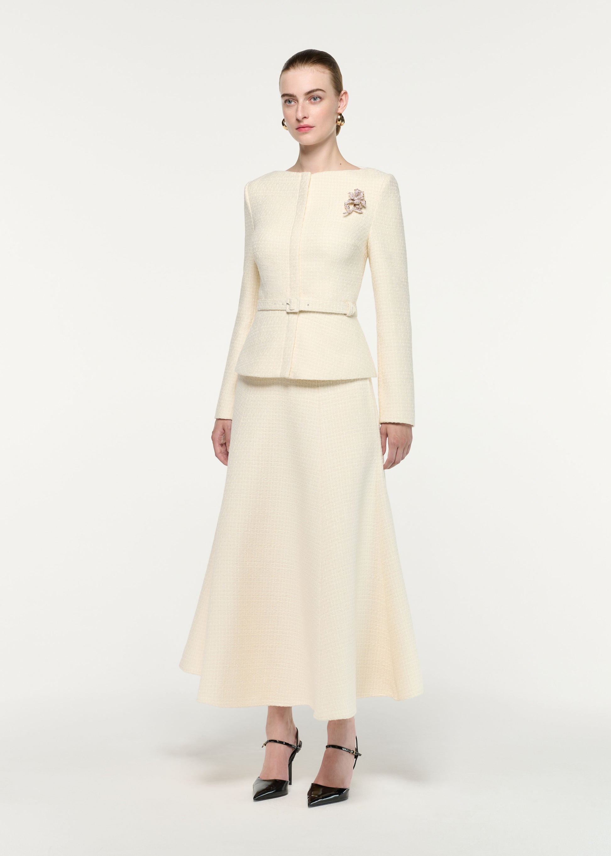 Side view of a model wearing the Flower Brooch Boucle Jacket
