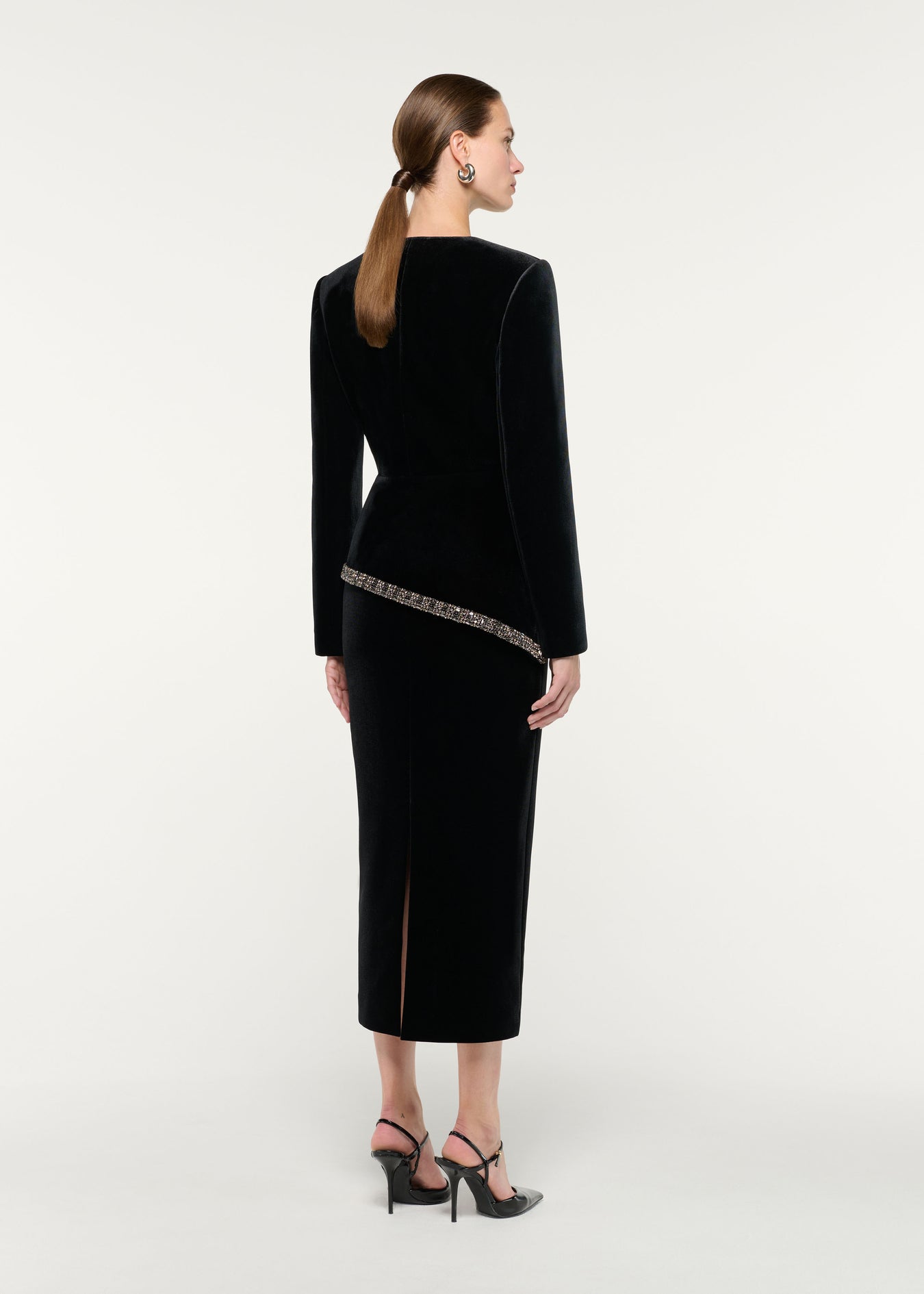 Back view of a model wearing the Velvet Embellished Trim Peplum Jacket