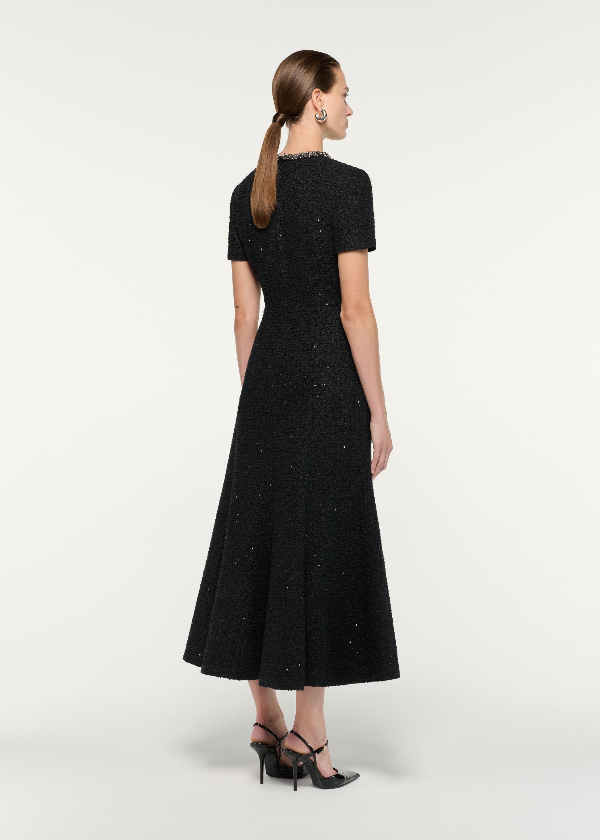 Back view of a model wearing the Embellished Neck Sequin Boucle Midi Dress