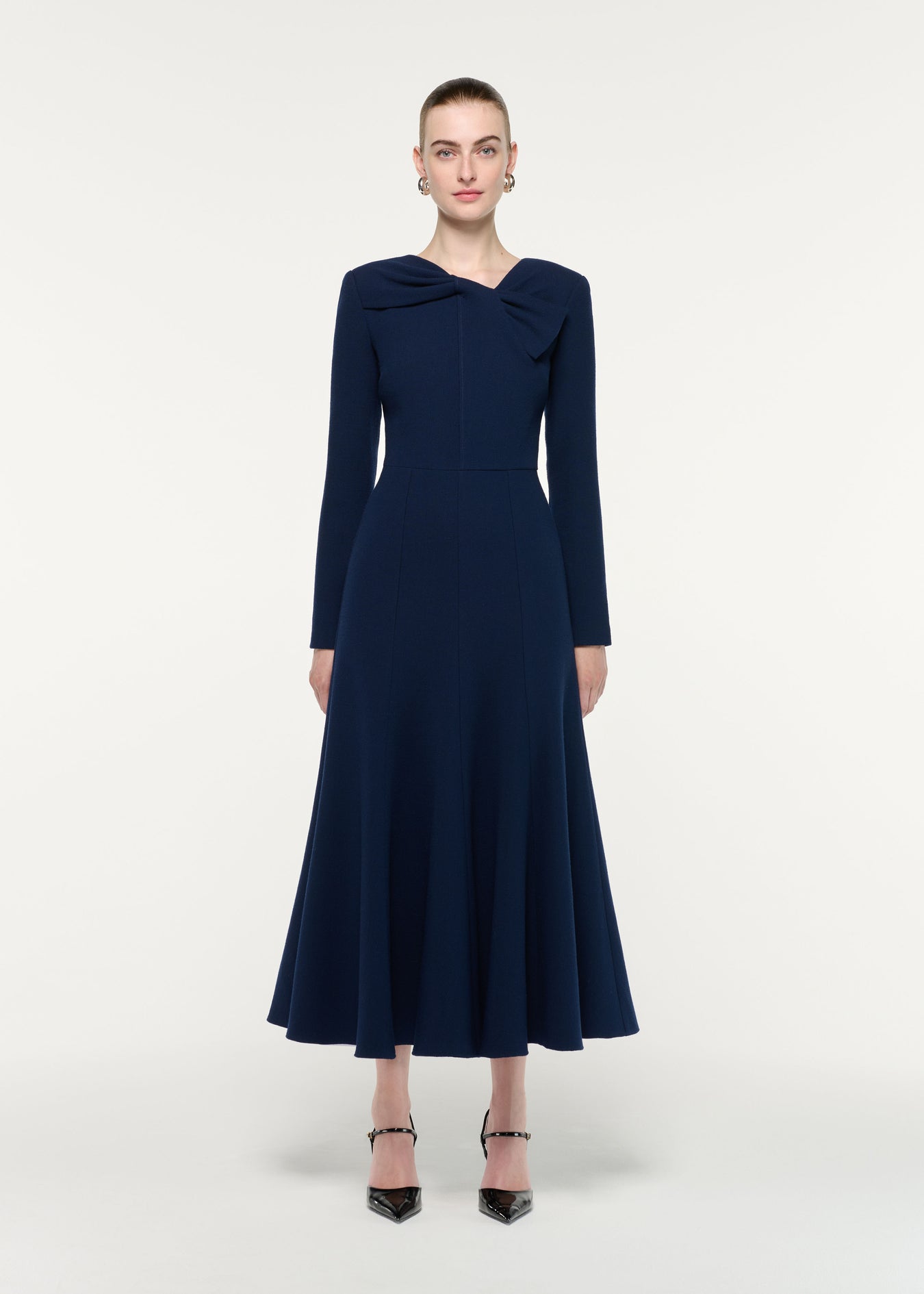 Front view of a model wearing the Asymmetric Bow Neck Wool Crepe Midi Dress