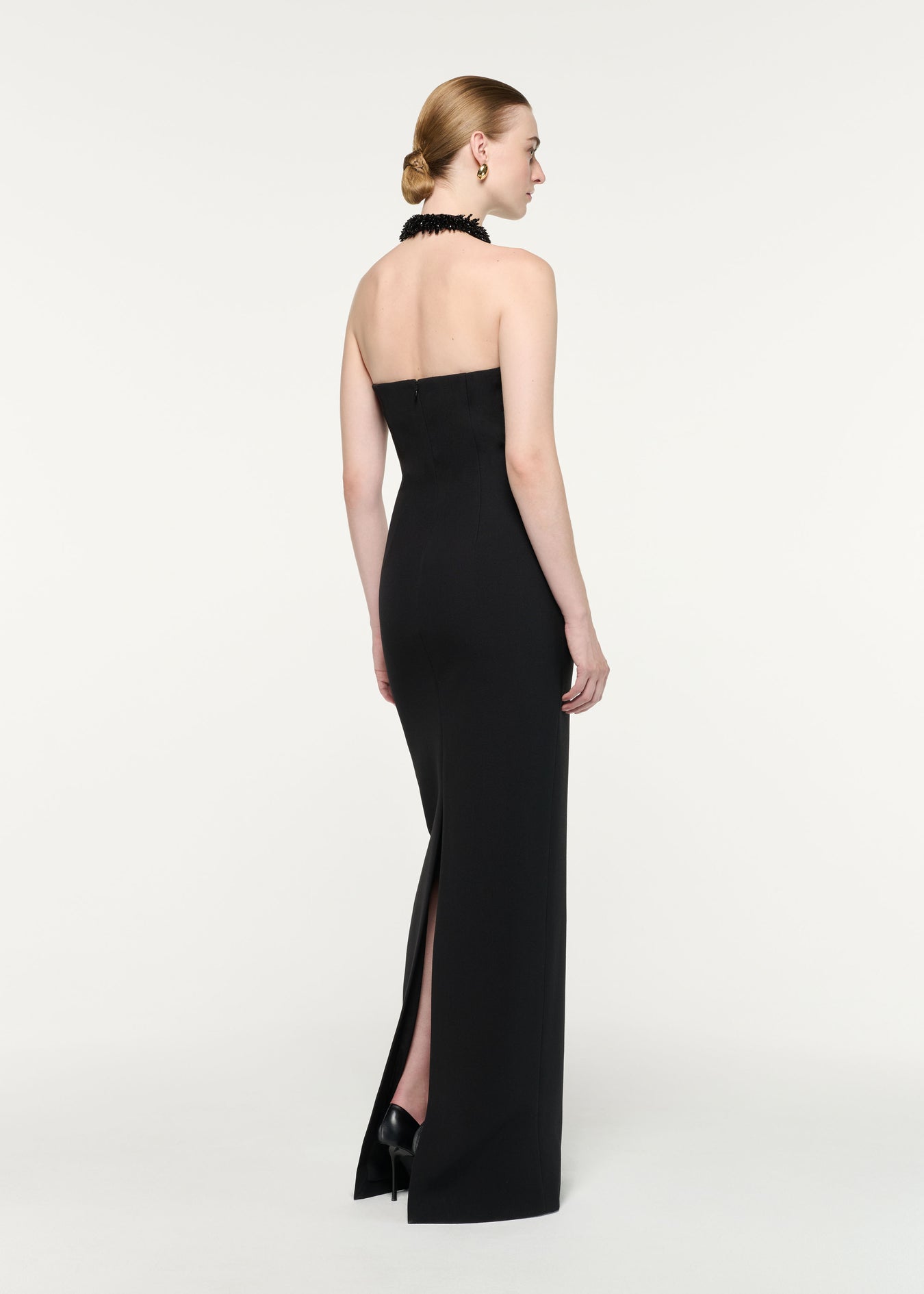Back view of a model wearing the Embellished Halter Neck Crepe Gown