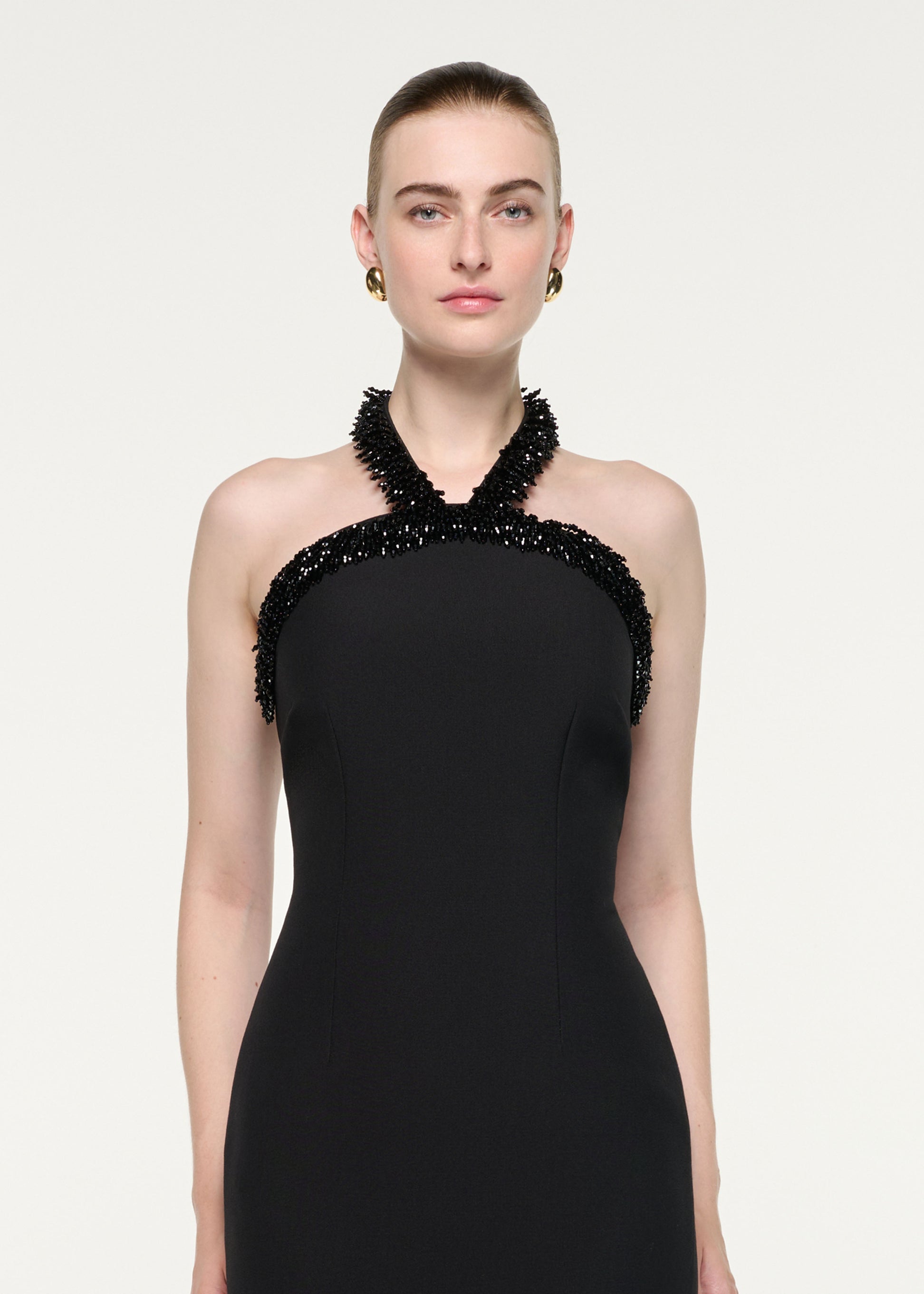 Close up of a model wearing the Embellished Halter Neck Crepe Gown