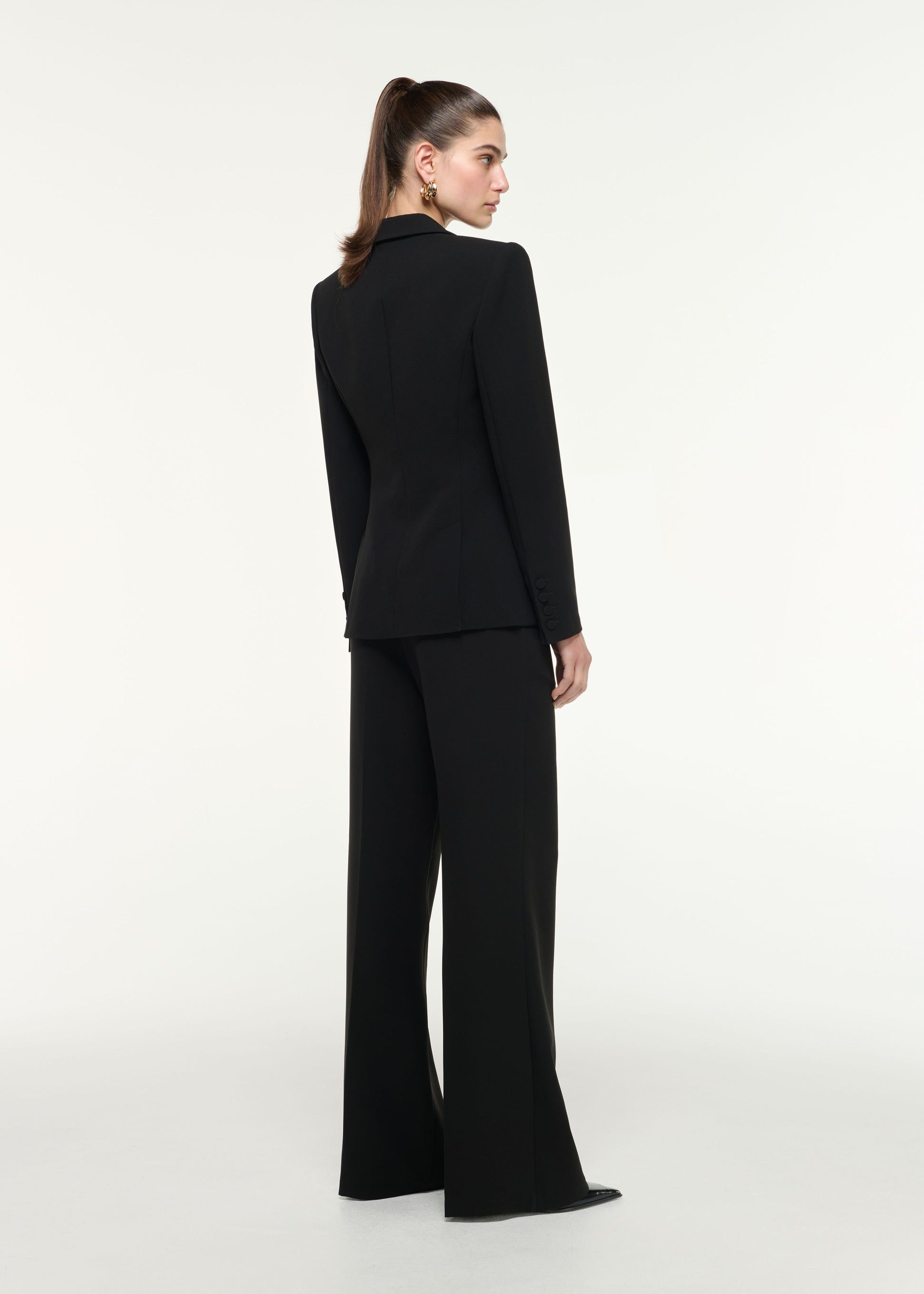 Back view of a model wearing the Wide Leg Heavy Cady Trouser in Black