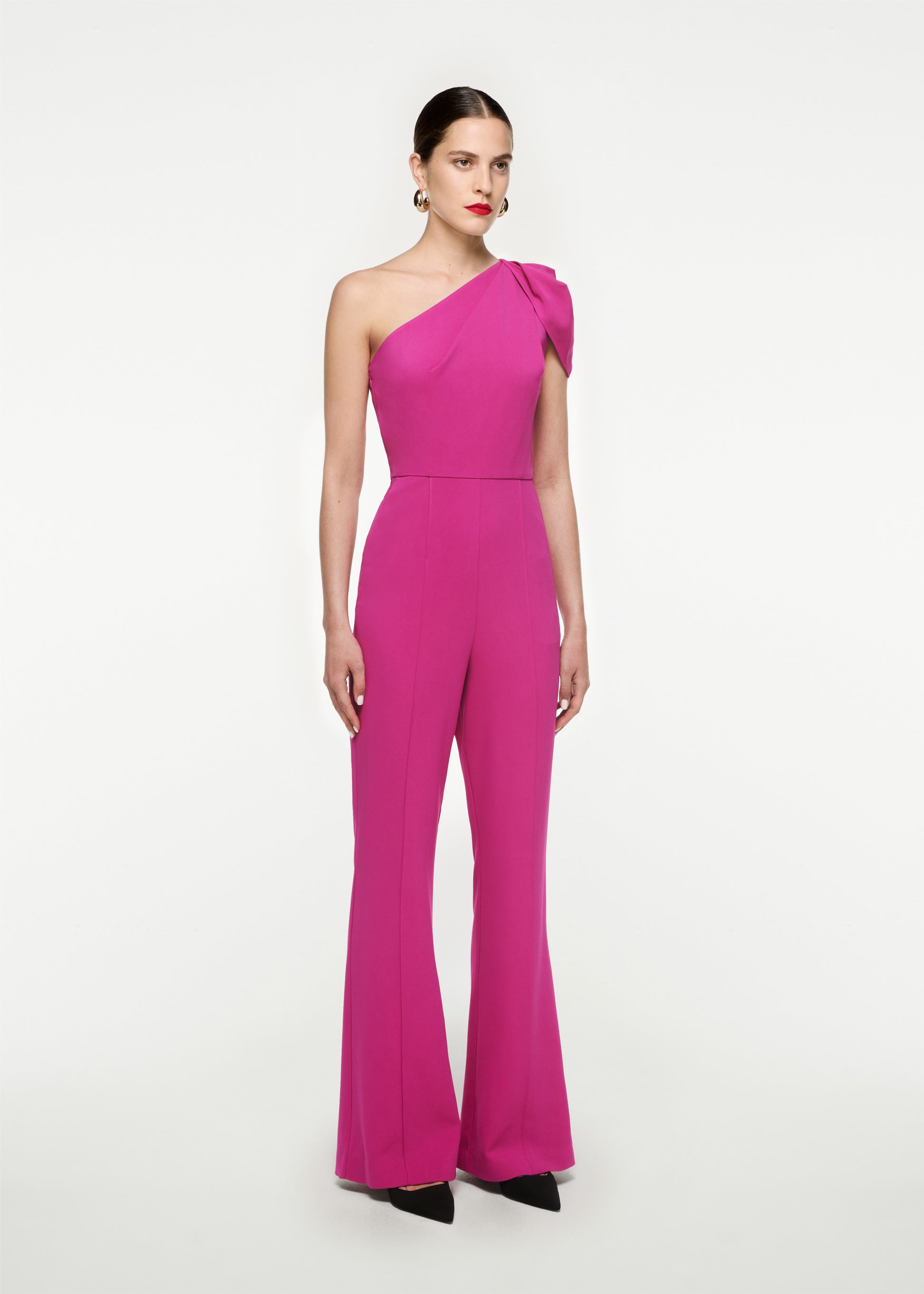 Woman wearing the Asymmetric Stretch Cady Jumpsuit in 