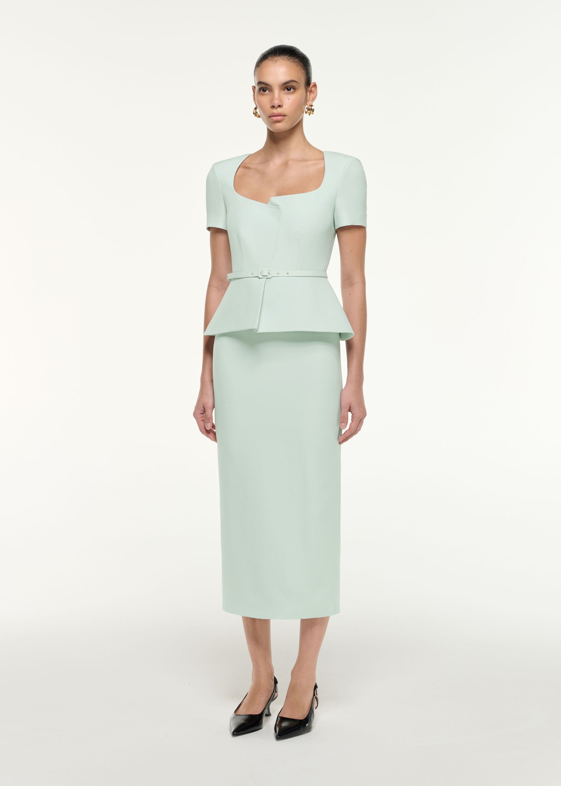 Side view of a model wearing the Peplum Wool Silk Midi Dress in Mint