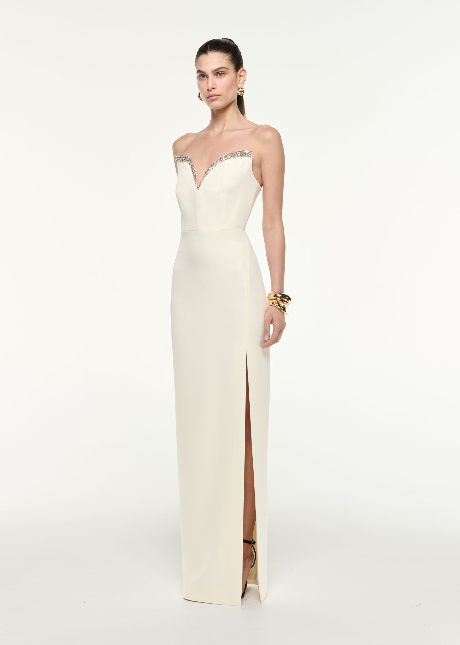 Side view of a model wearing the Diamante Sweetheart Strapless Gown in Cream