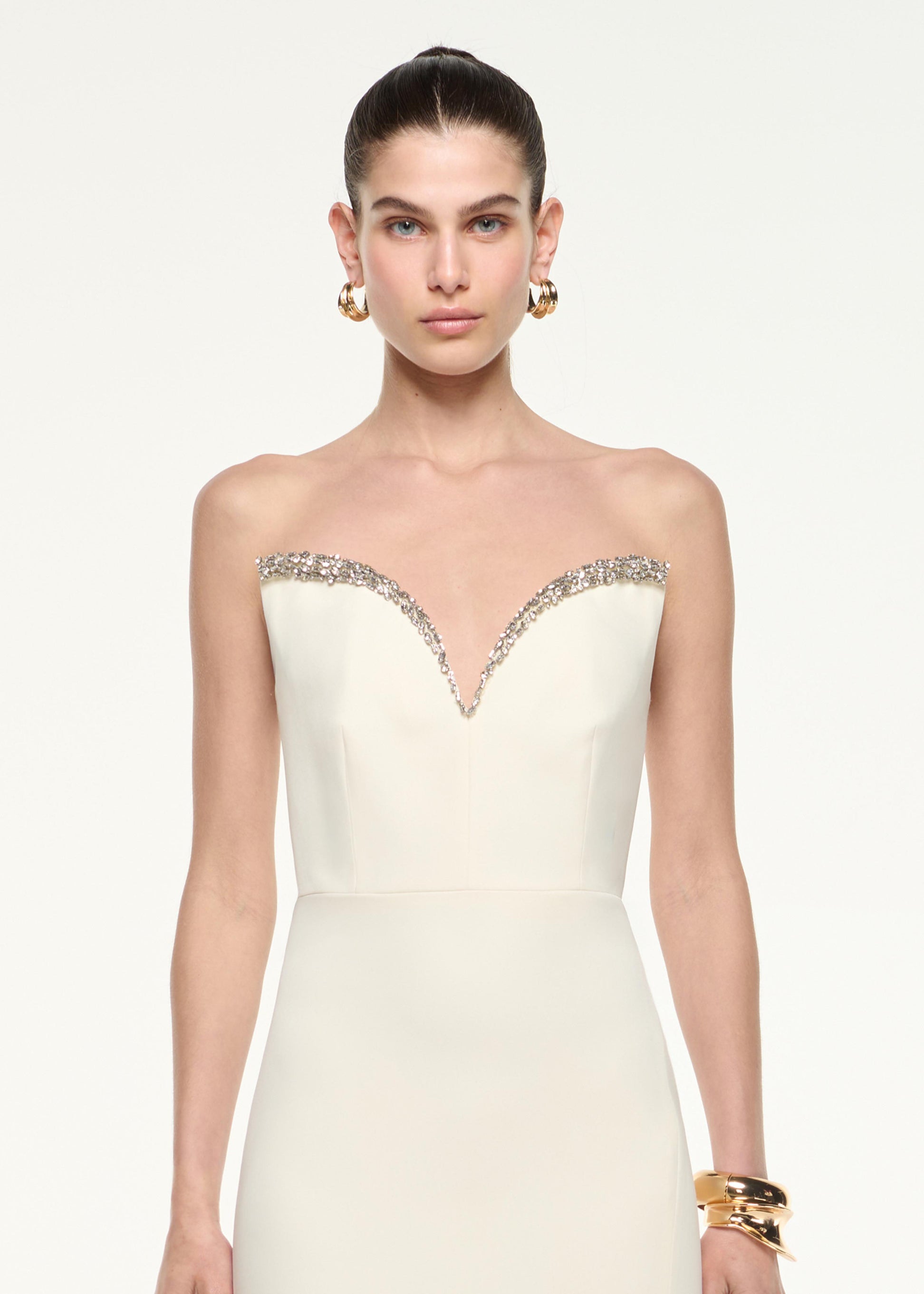 Close up of a model wearing the Diamante Sweetheart Strapless Gown in Cream