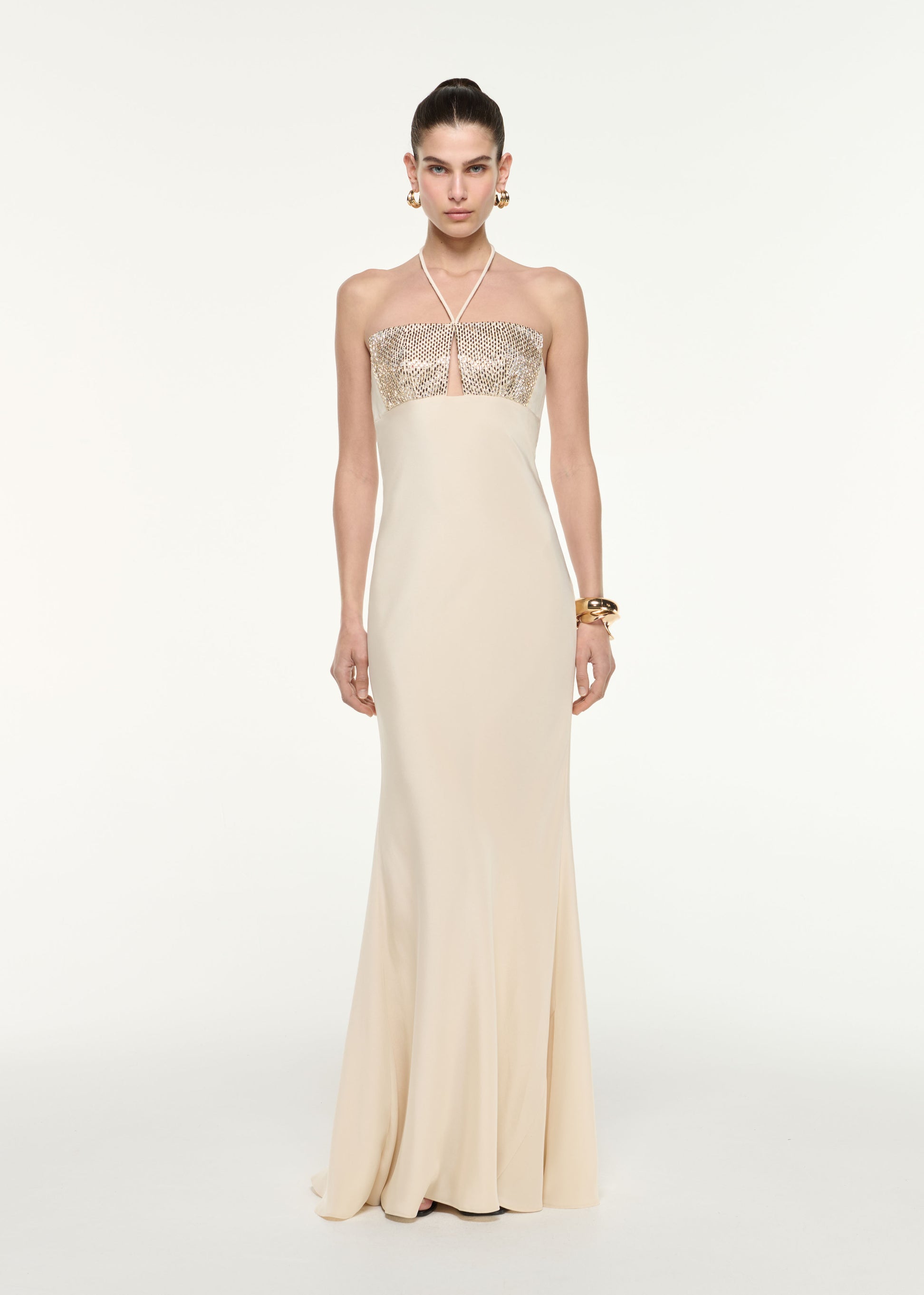 Front view of a model wearing the Diamante Halter Neck Silk Gown in Champagne