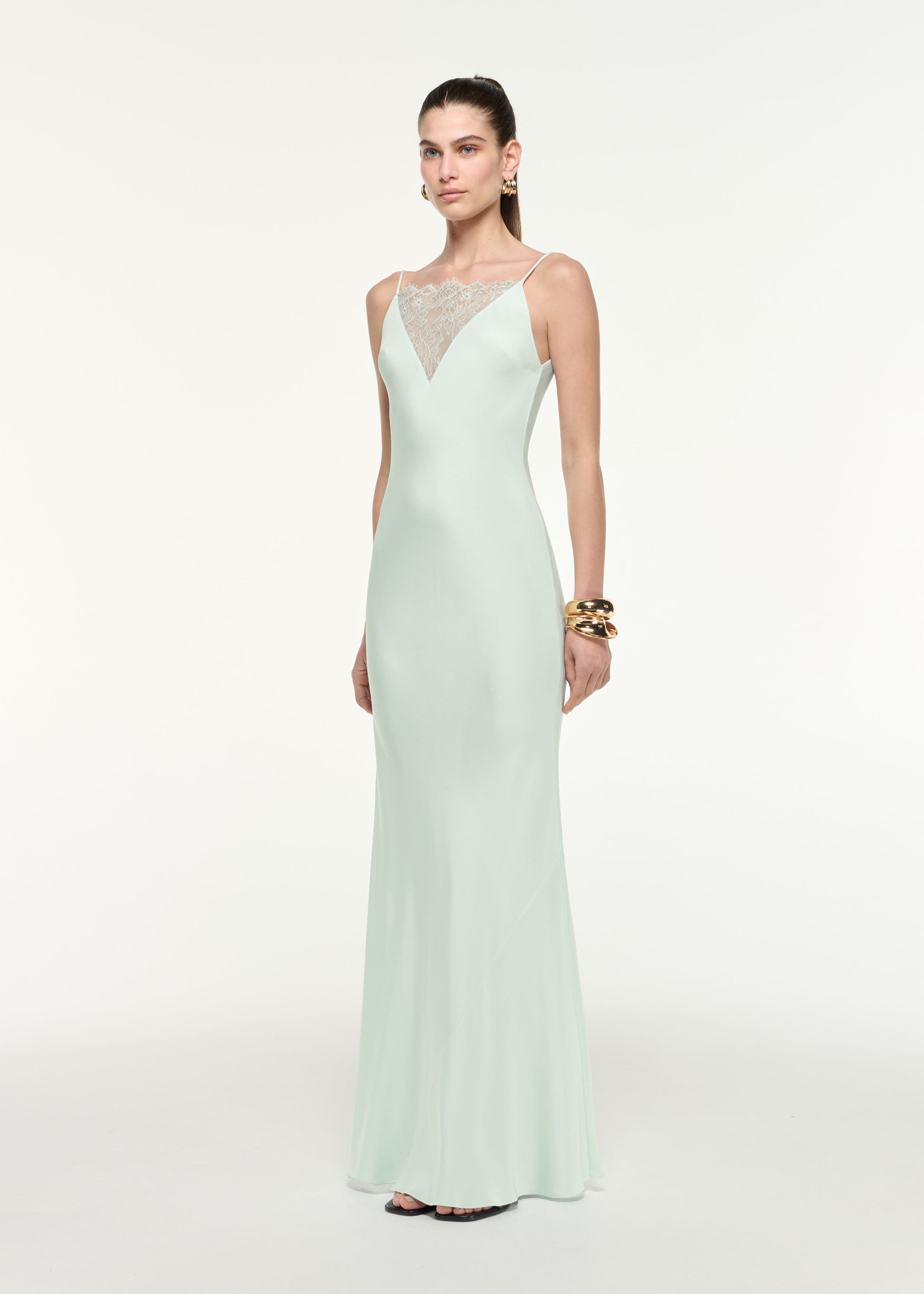 Side view of a model wearing the Silk Lace Gown in Mint
