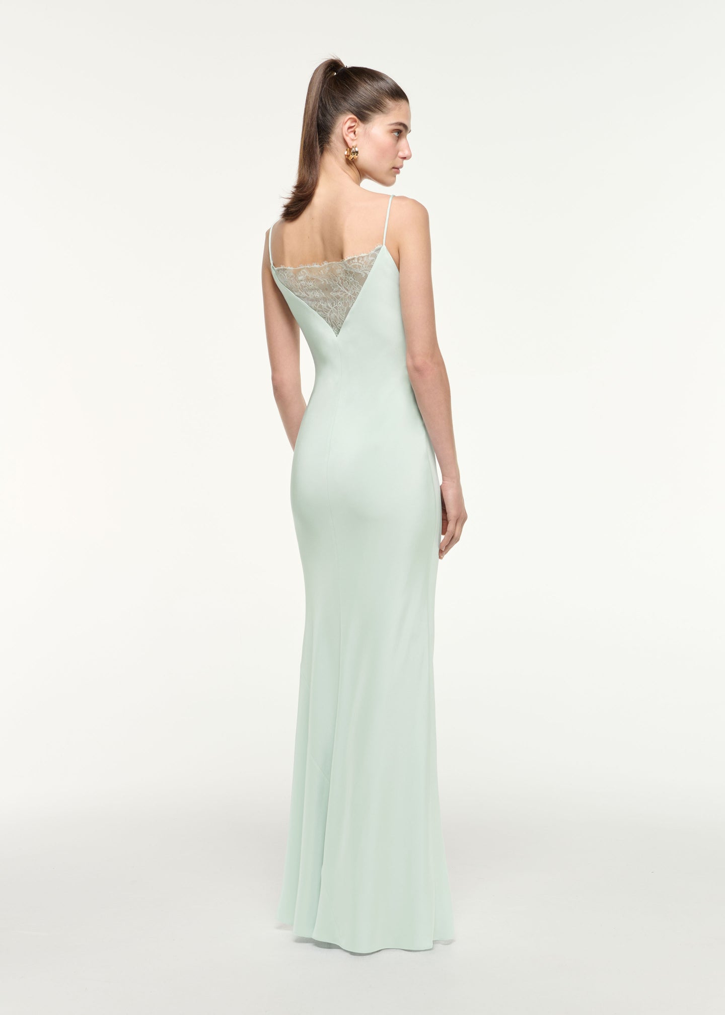 Back view of a model wearing the Silk Lace Gown in Mint
