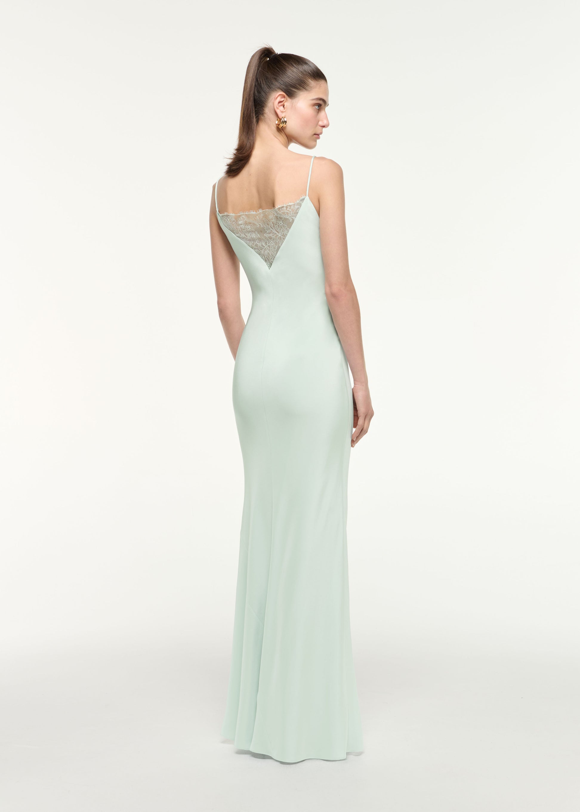 Back view of a model wearing the Silk Lace Gown in Mint