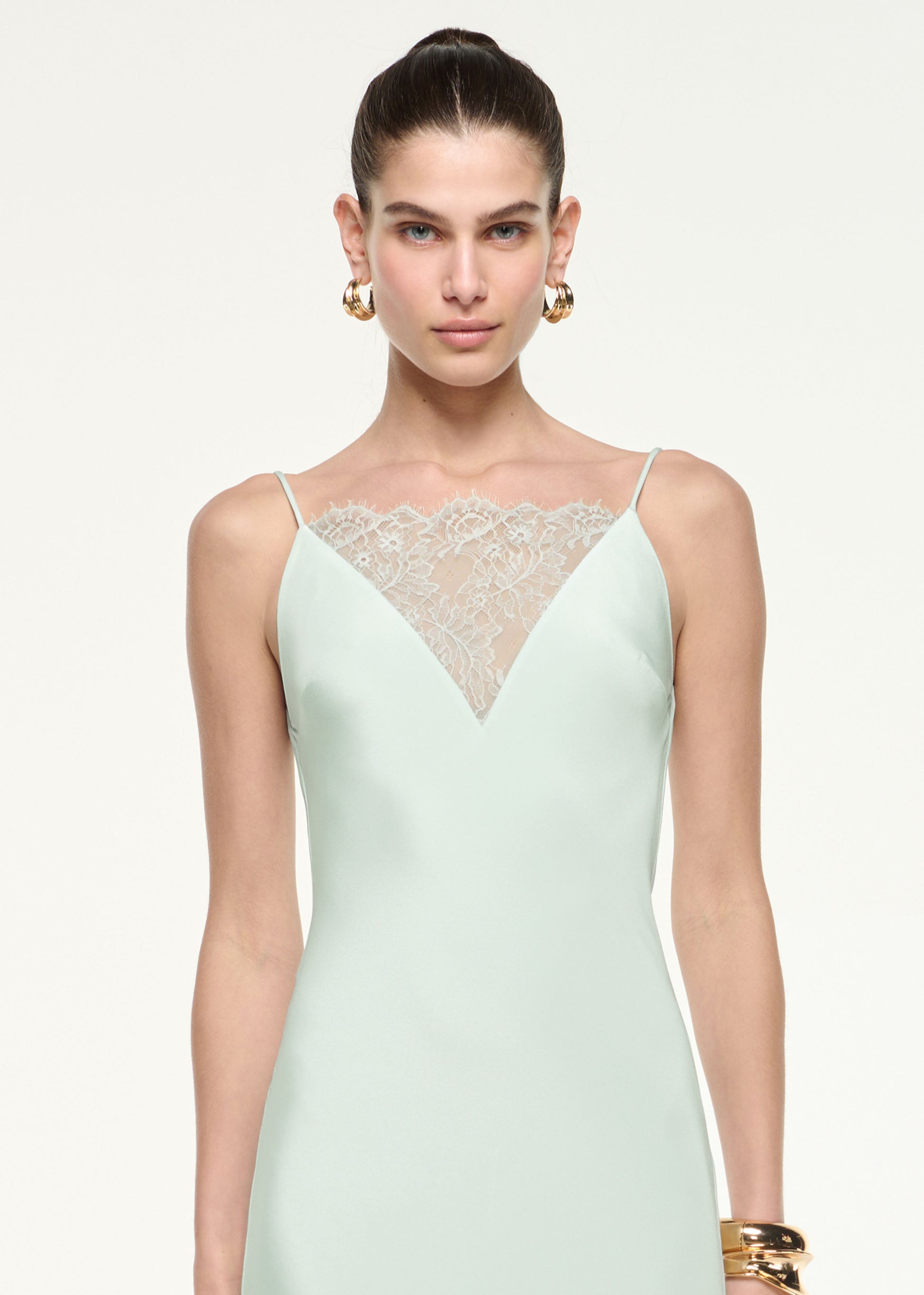 Close up of a model wearing the Silk Lace Gown in Mint