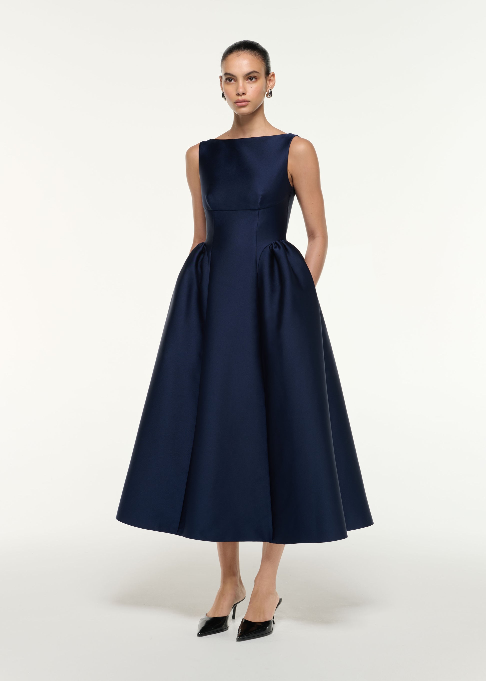 Side view of a model wearing the Taffeta Midi Dress in Navy