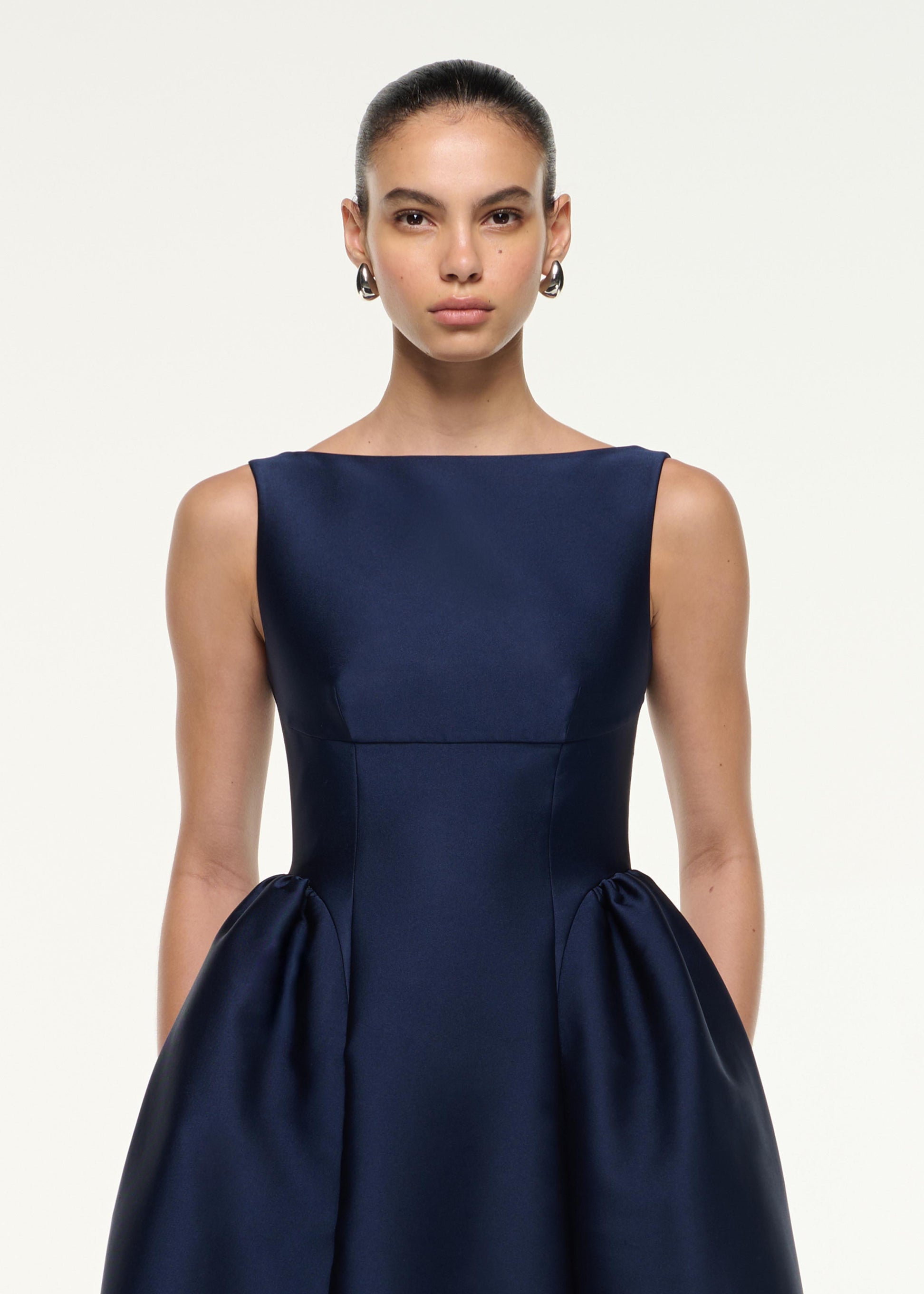 Close up of a model wearing the Taffeta Midi Dress in Navy