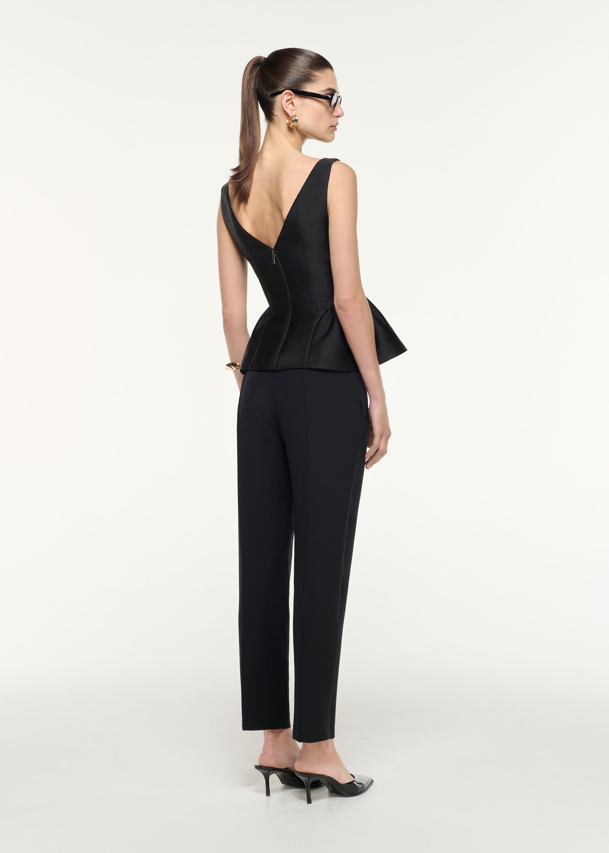 Back view of a model wearing the Gathered Taffeta Top in Black