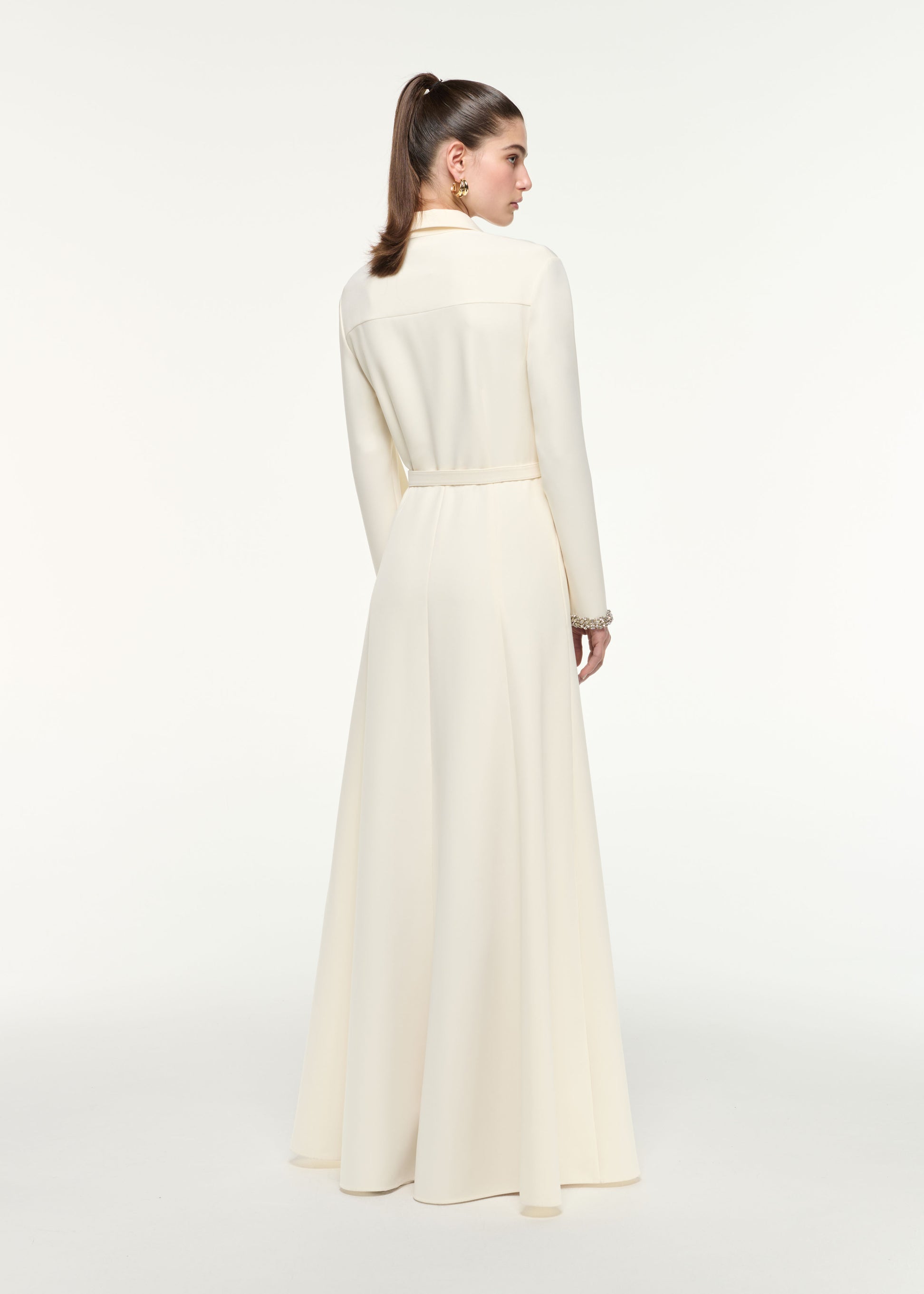 Back view of a model wearing the Shirt Dress in Cream