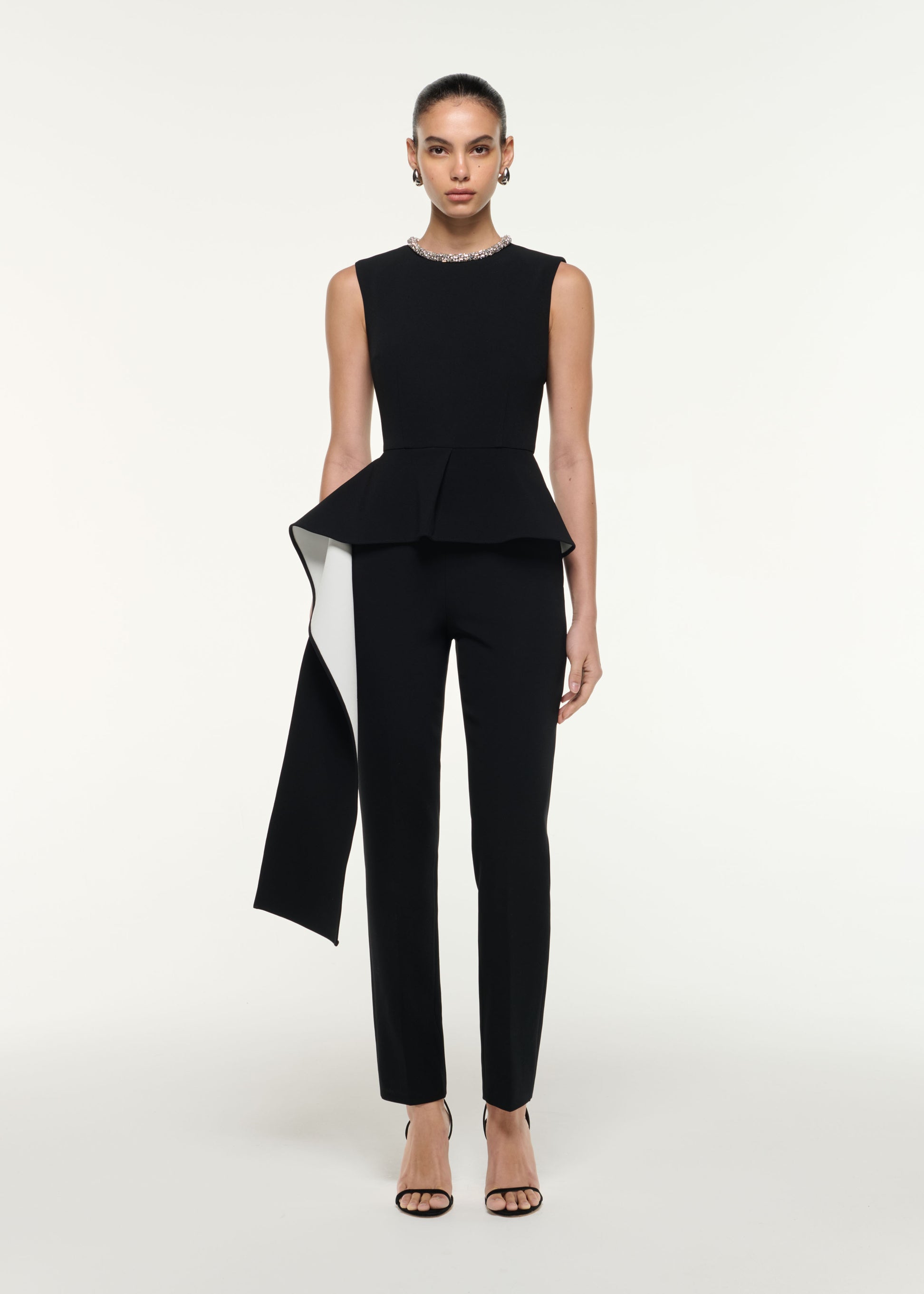 Front view of a model wearing the Waist Drape Jumpsuit in Monochrome