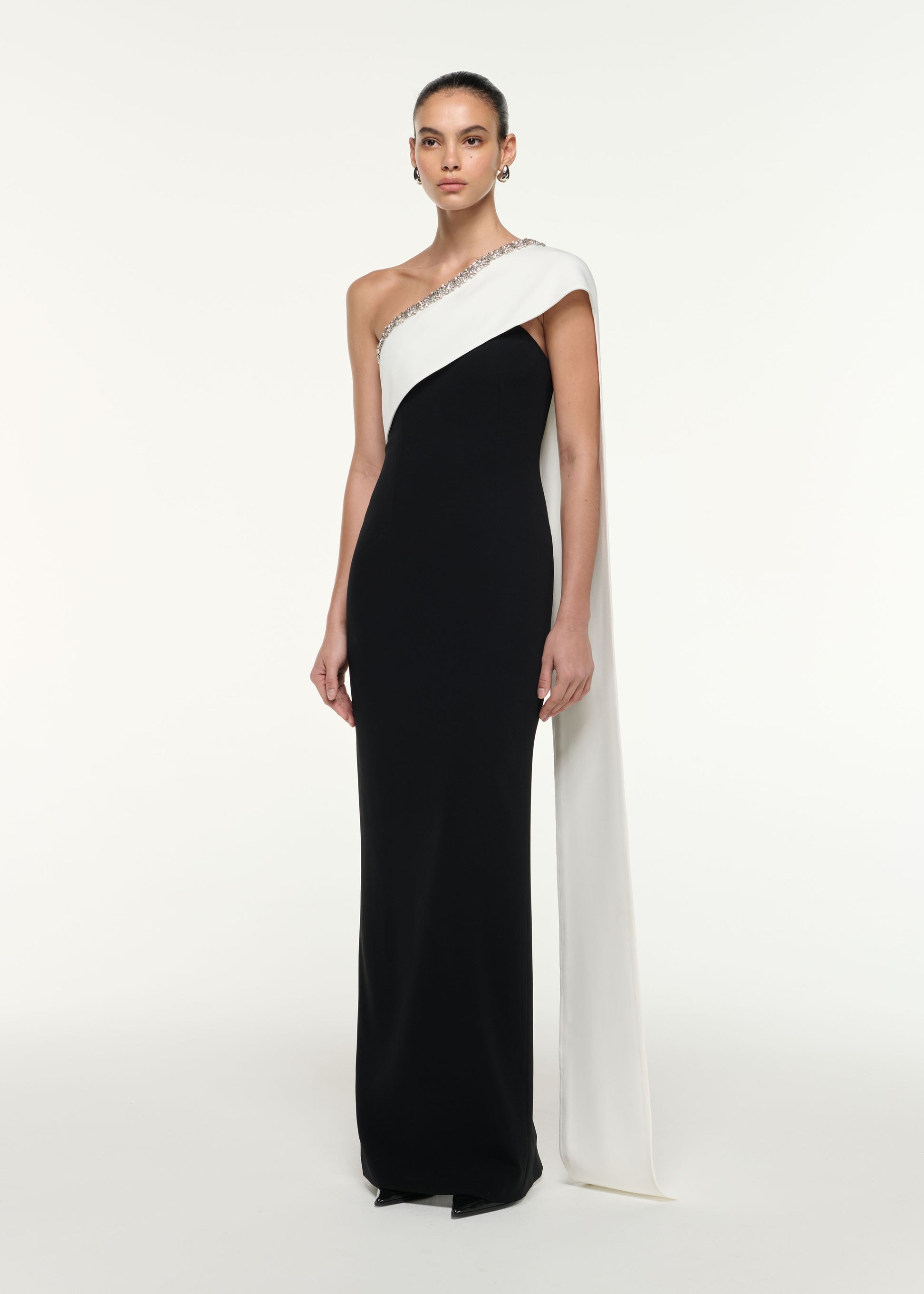 Side view of a model wearing the Satin Crepe Sash Gown in Monochrome