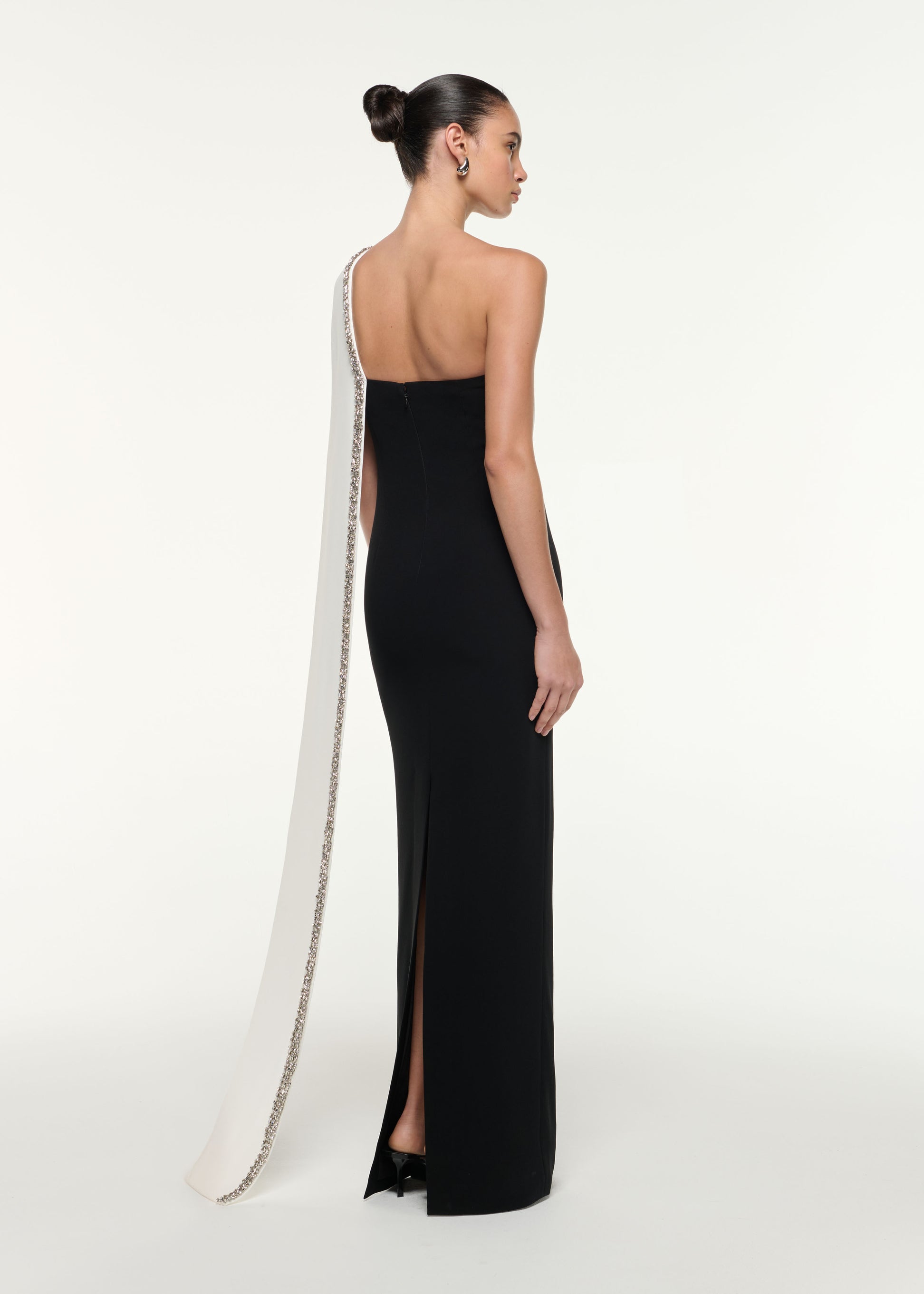 Back view of a model wearing the Satin Crepe Sash Gown in Monochrome