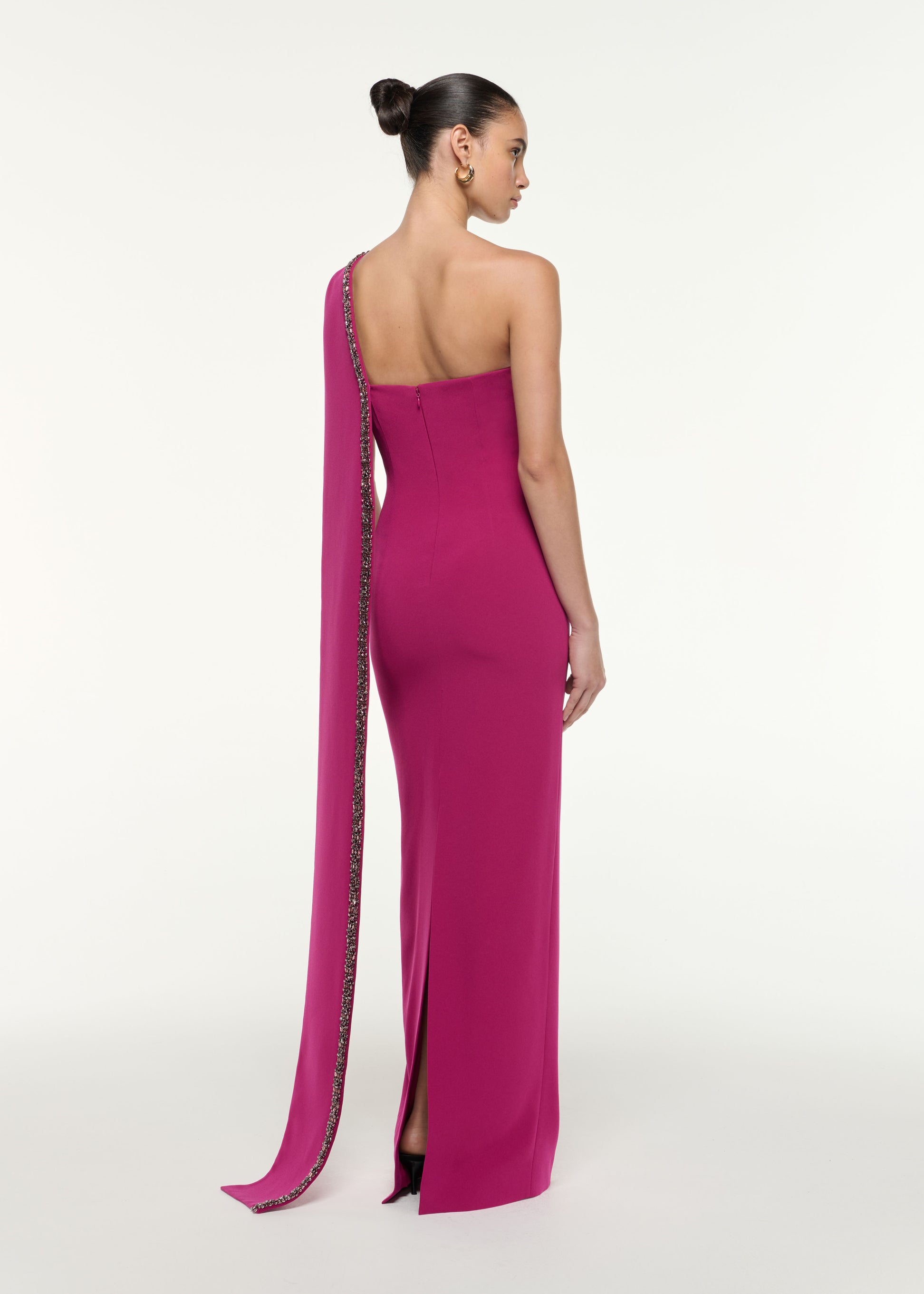 Back view of a model wearing the Sash Satin Crepe Gown in Dark Pink