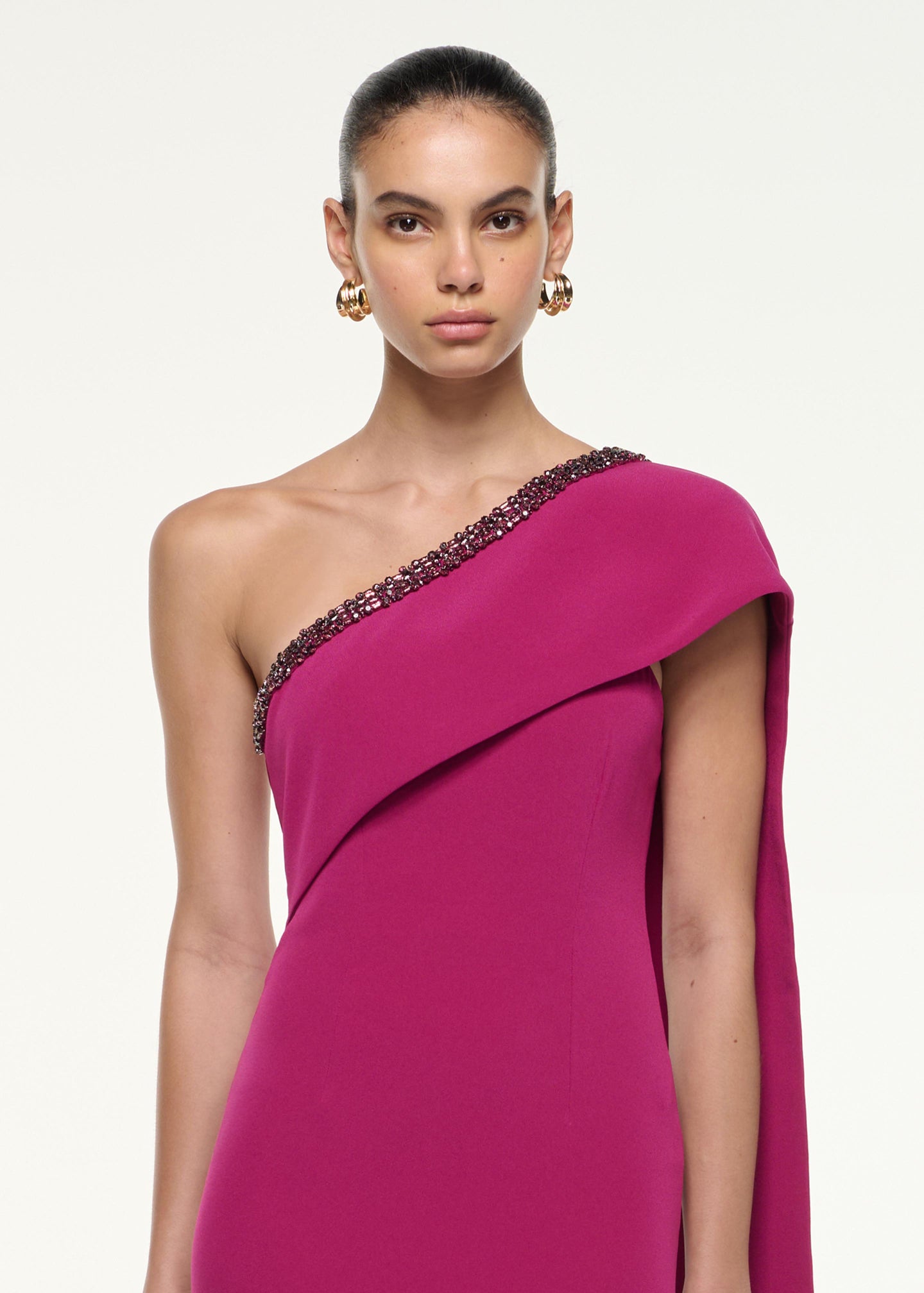 Close up of a model wearing the Sash Satin Crepe Gown in Dark Pink