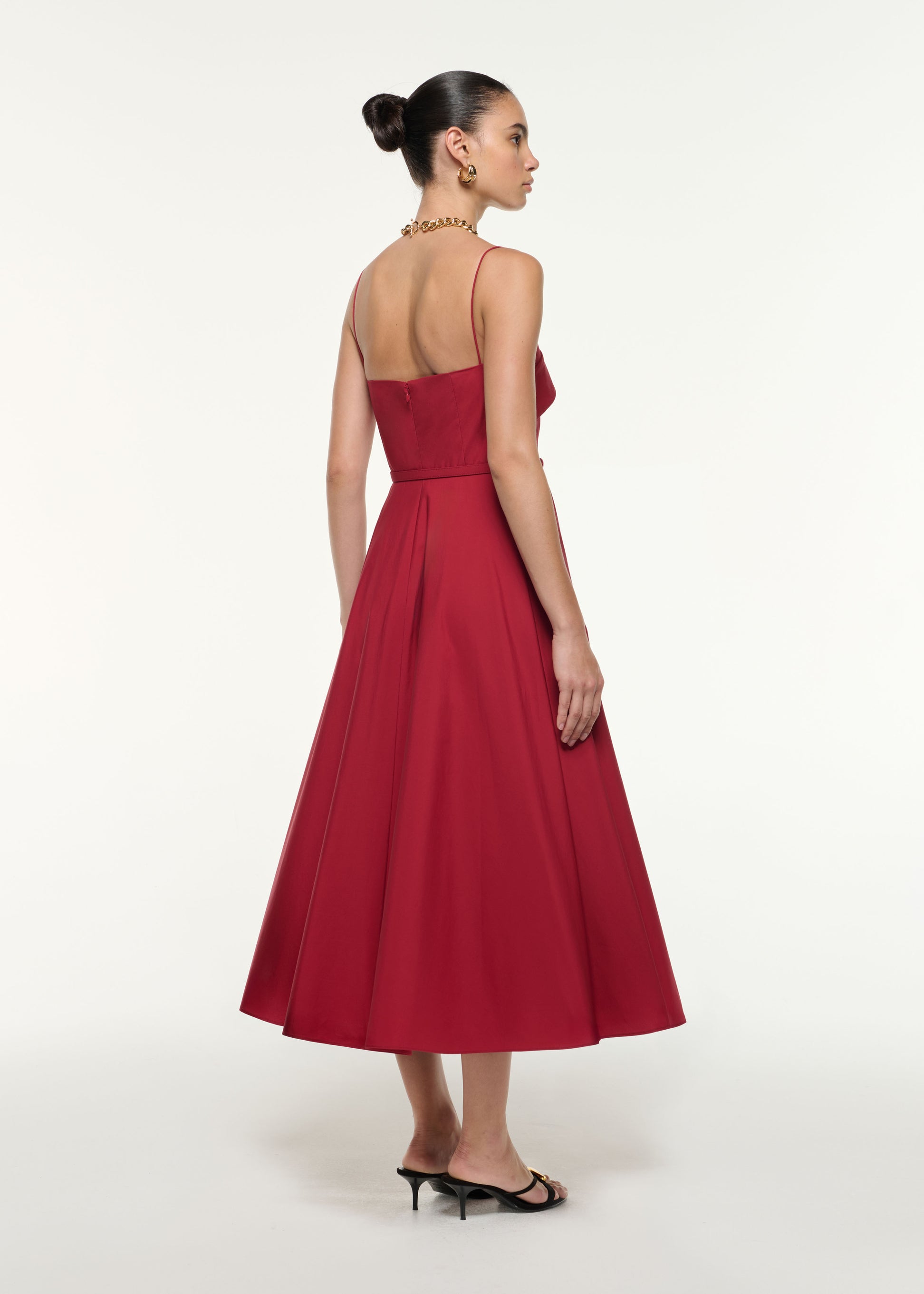 Back view of a model wearing the Cotton Poplin Strap Midi Dress in Dark Red