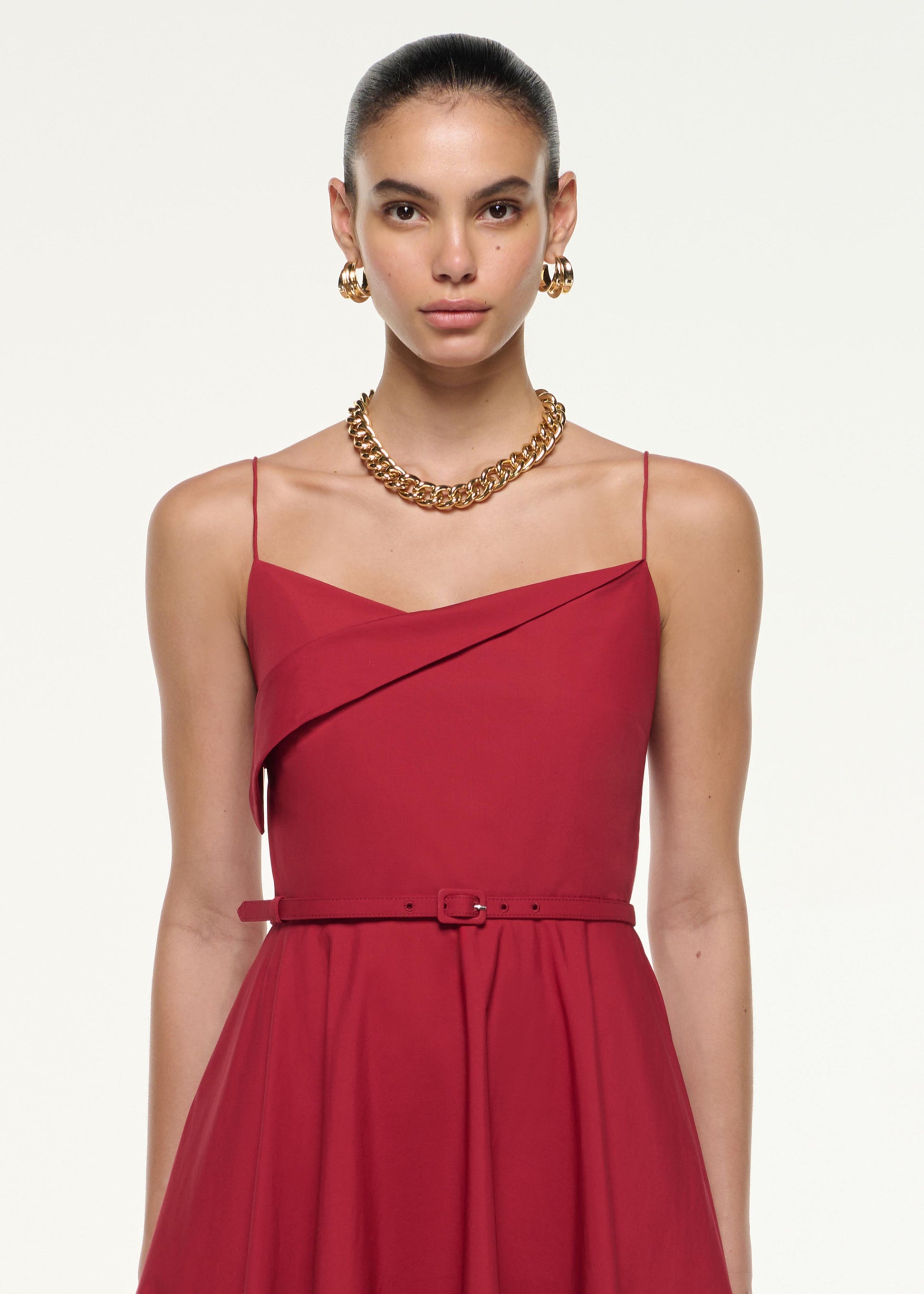 Close up of a model wearing the Cotton Poplin Strap Midi Dress in Dark Red