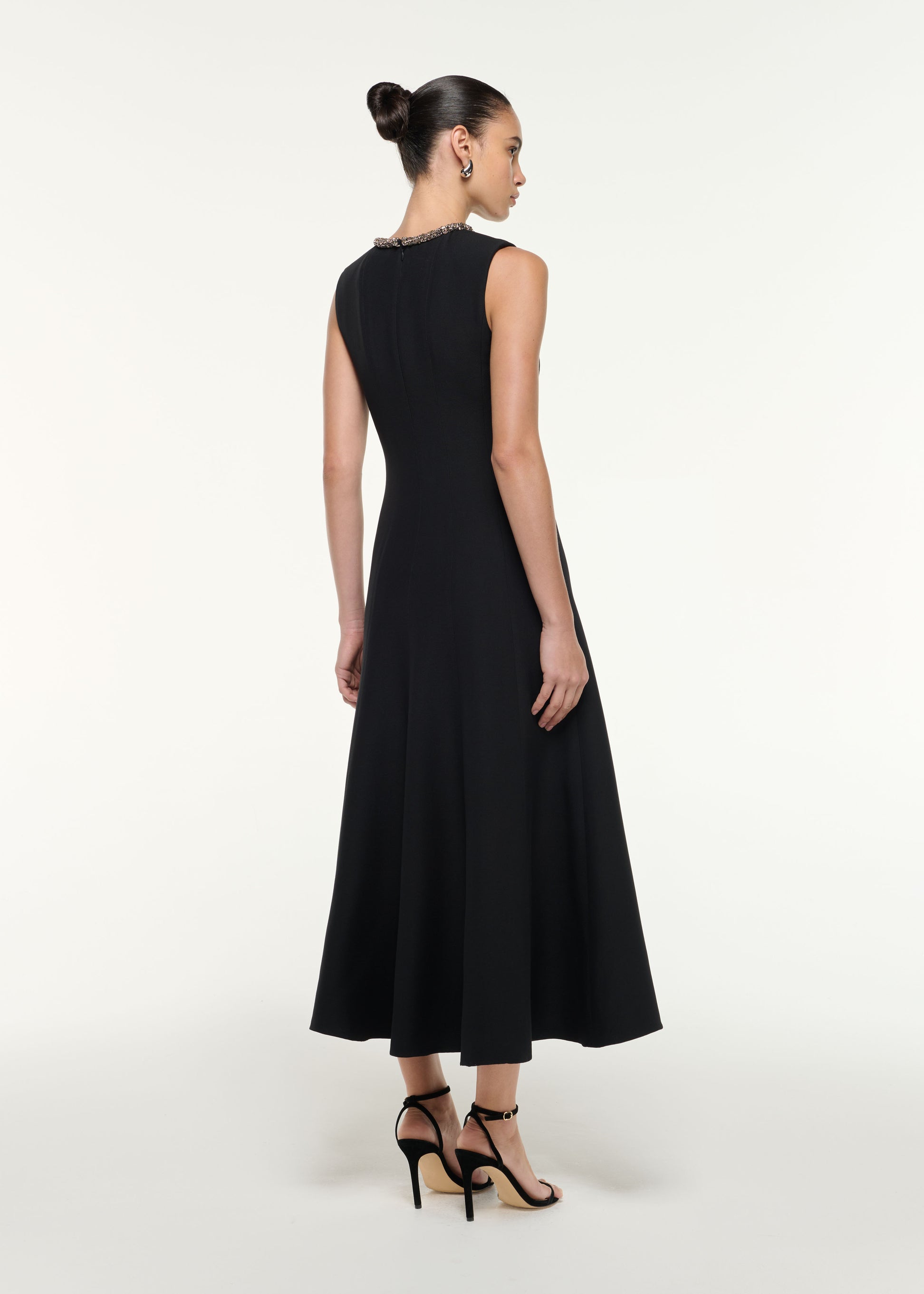 Back view of a model wearing the Diamante Trim Wool Silk Midi Dress in Black