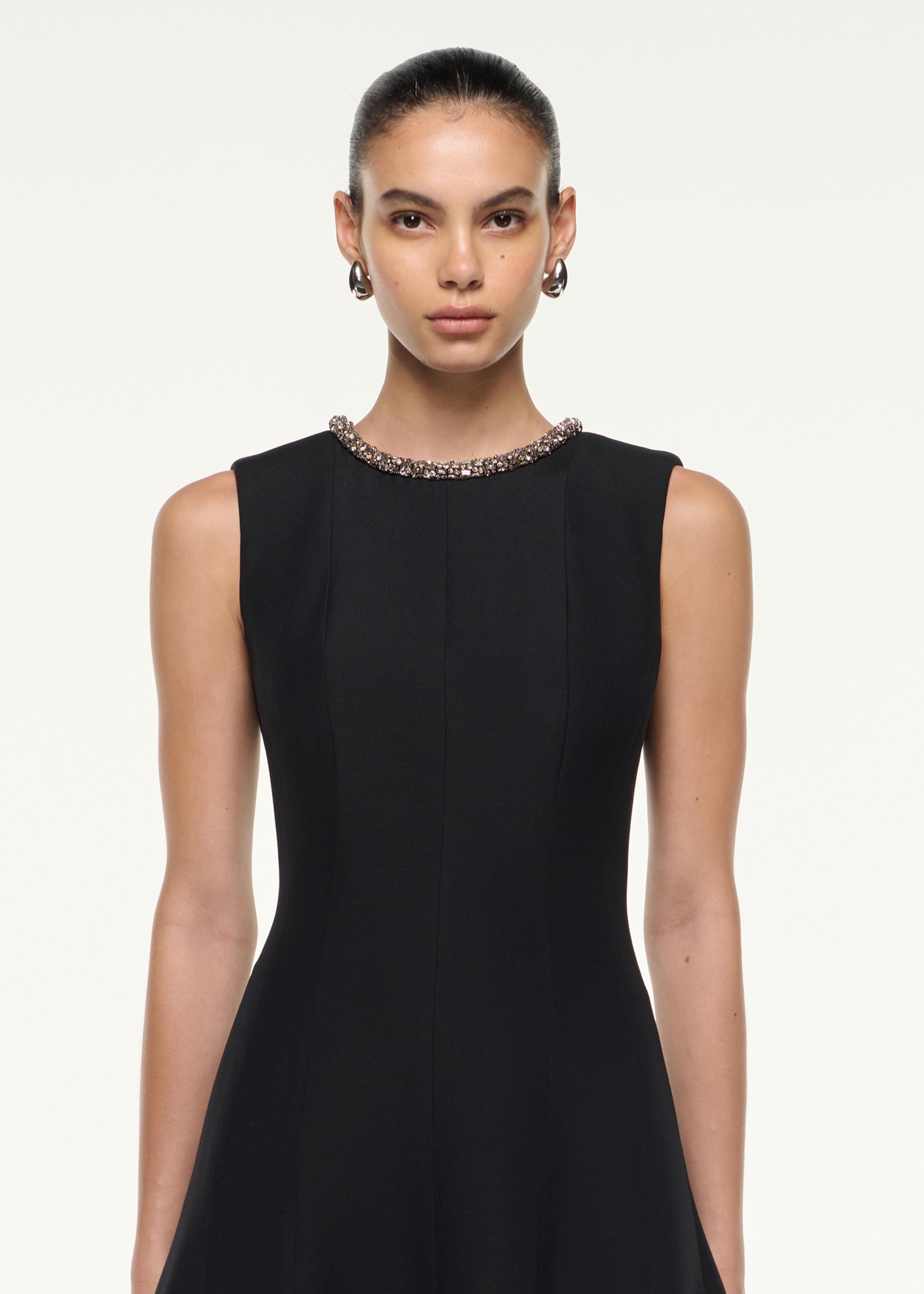 Close up of a model wearing the Diamante Trim Wool Silk Midi Dress in Black