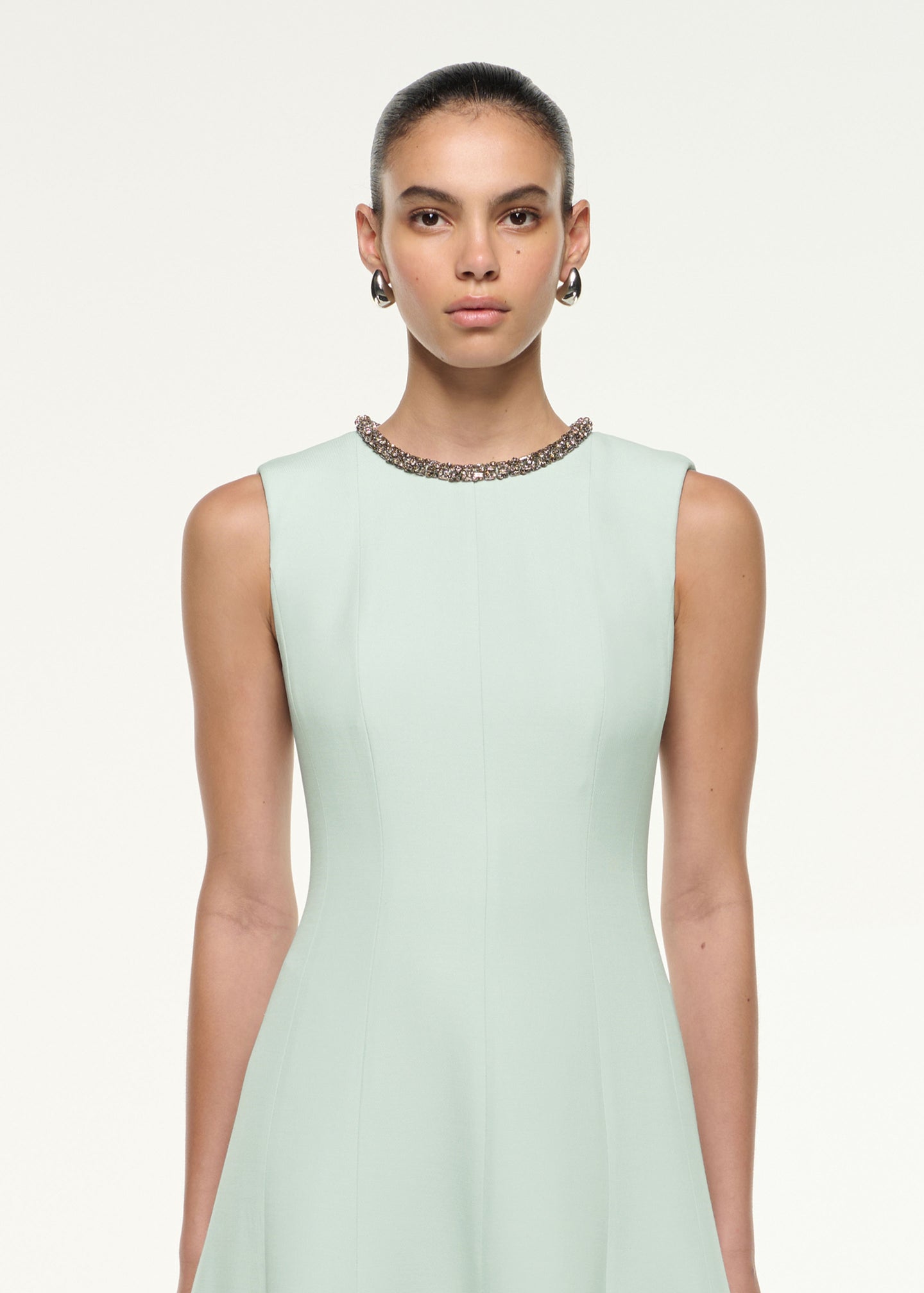 Close up of a model wearing the Diamante Trim Wool Silk Midi Dress in Mint