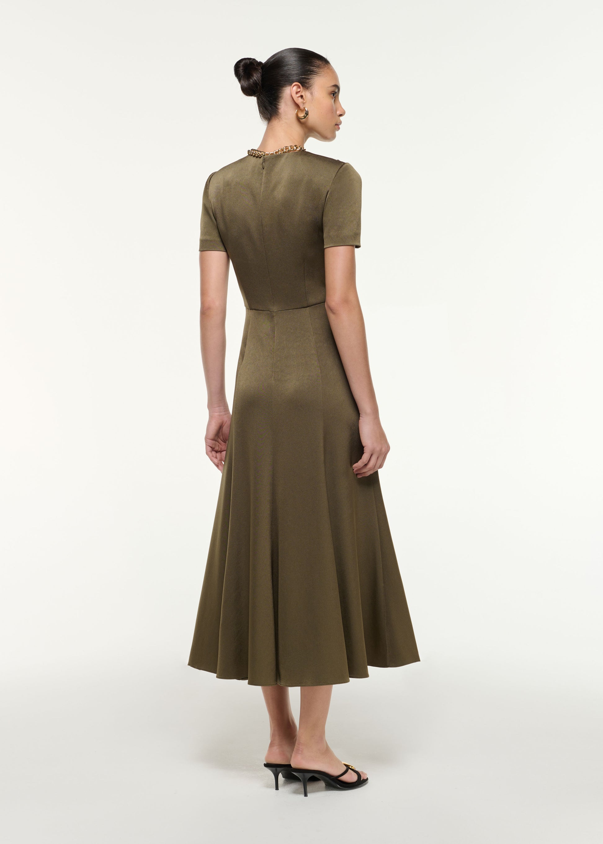 Back view of a model wearing the Satin Crepe Drape Midi Dress in Khaki