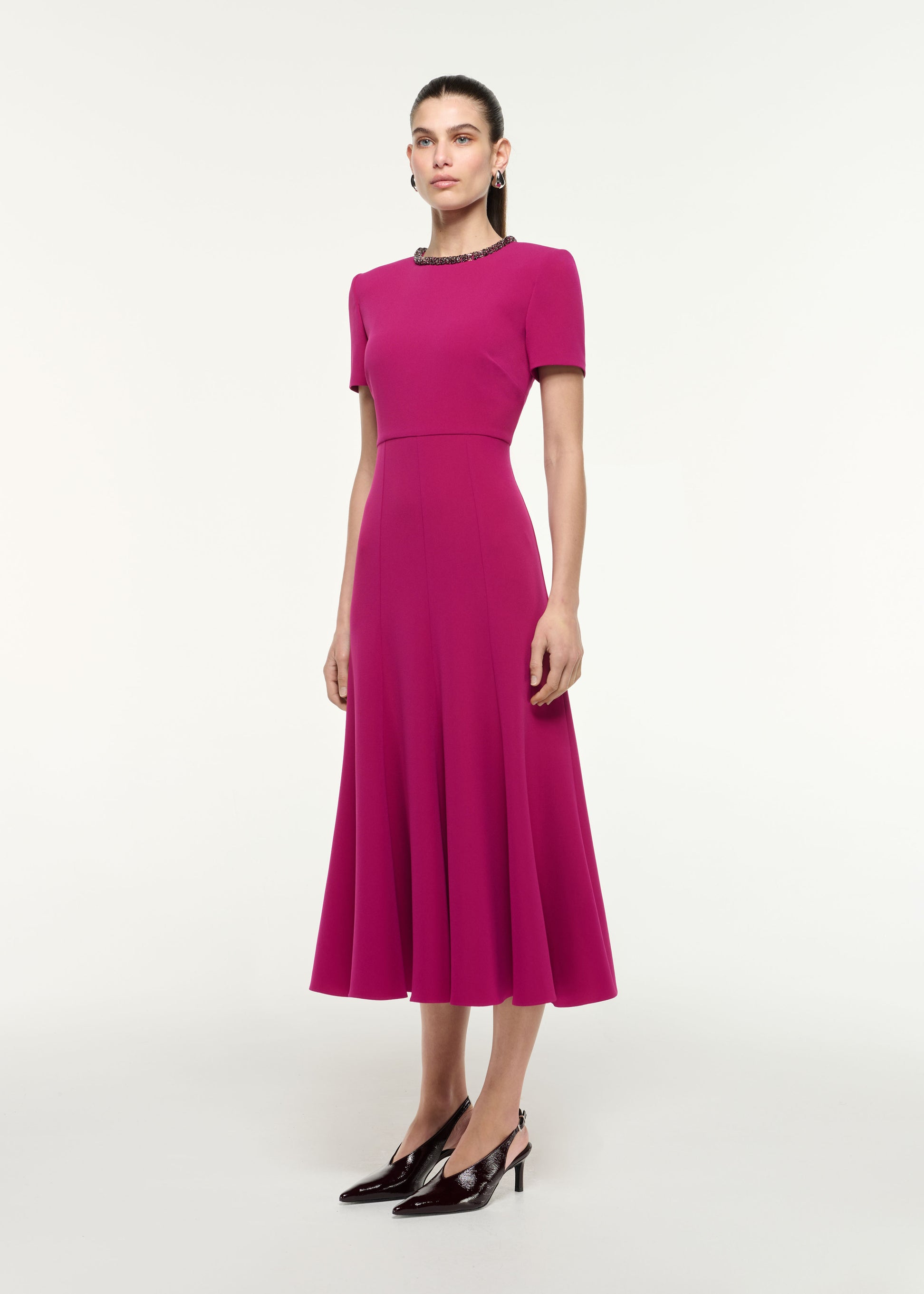 Side view of a model wearing the Diamante Trim Midi Dress in Dark Pink