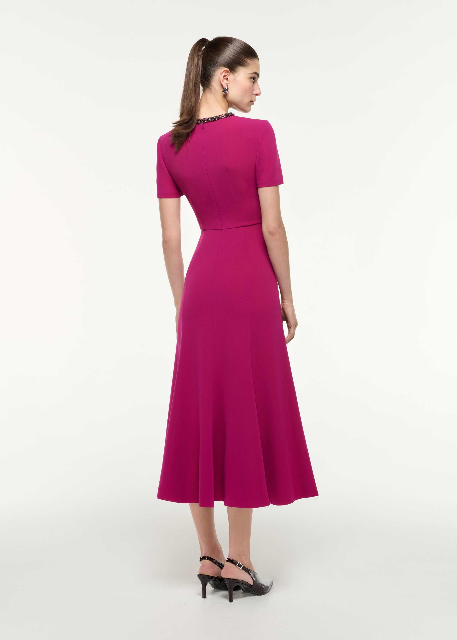 Back view of a model wearing the Diamante Trim Midi Dress in Dark Pink