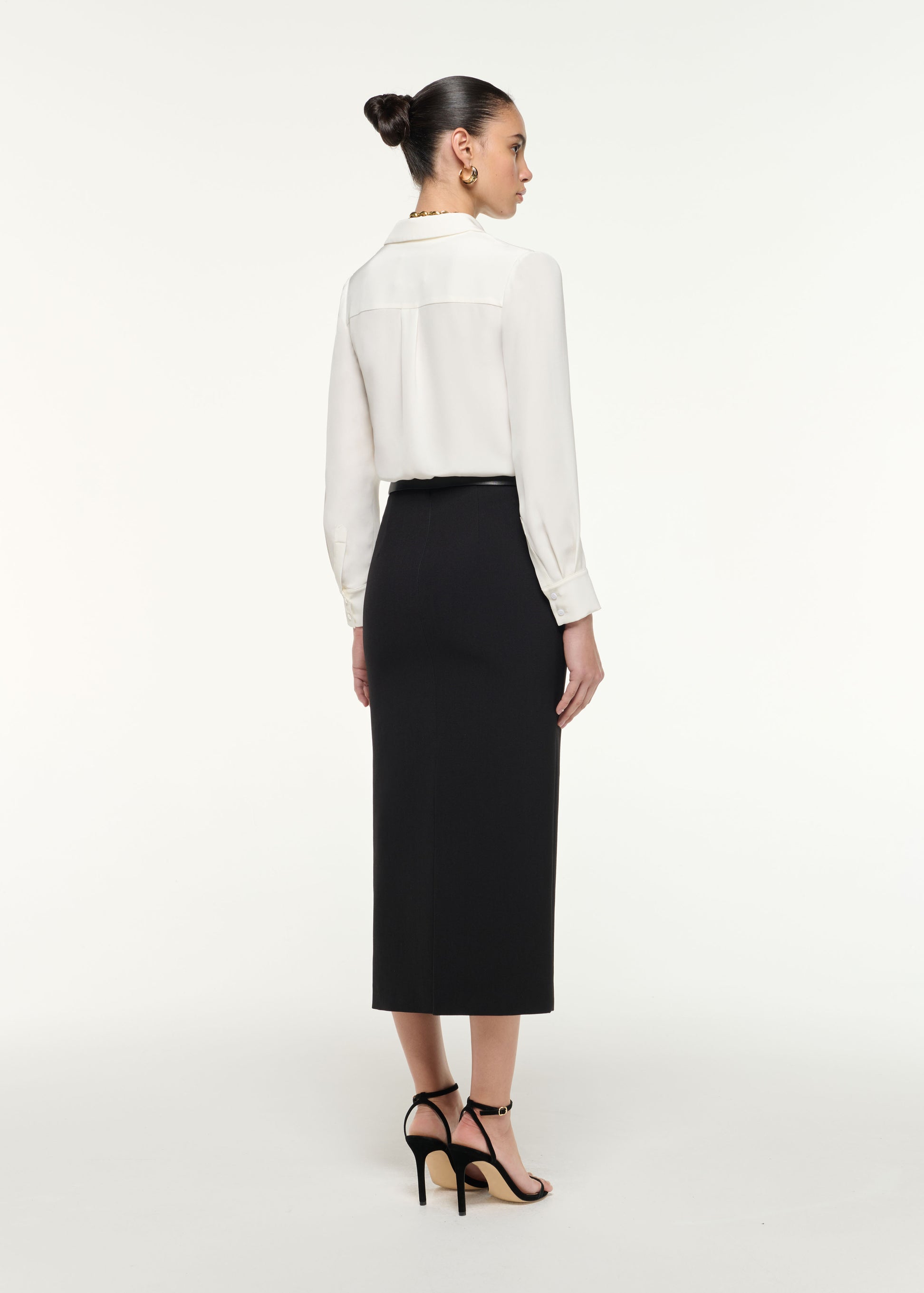 Back view of a model wearing the Silk Bodysuit in White