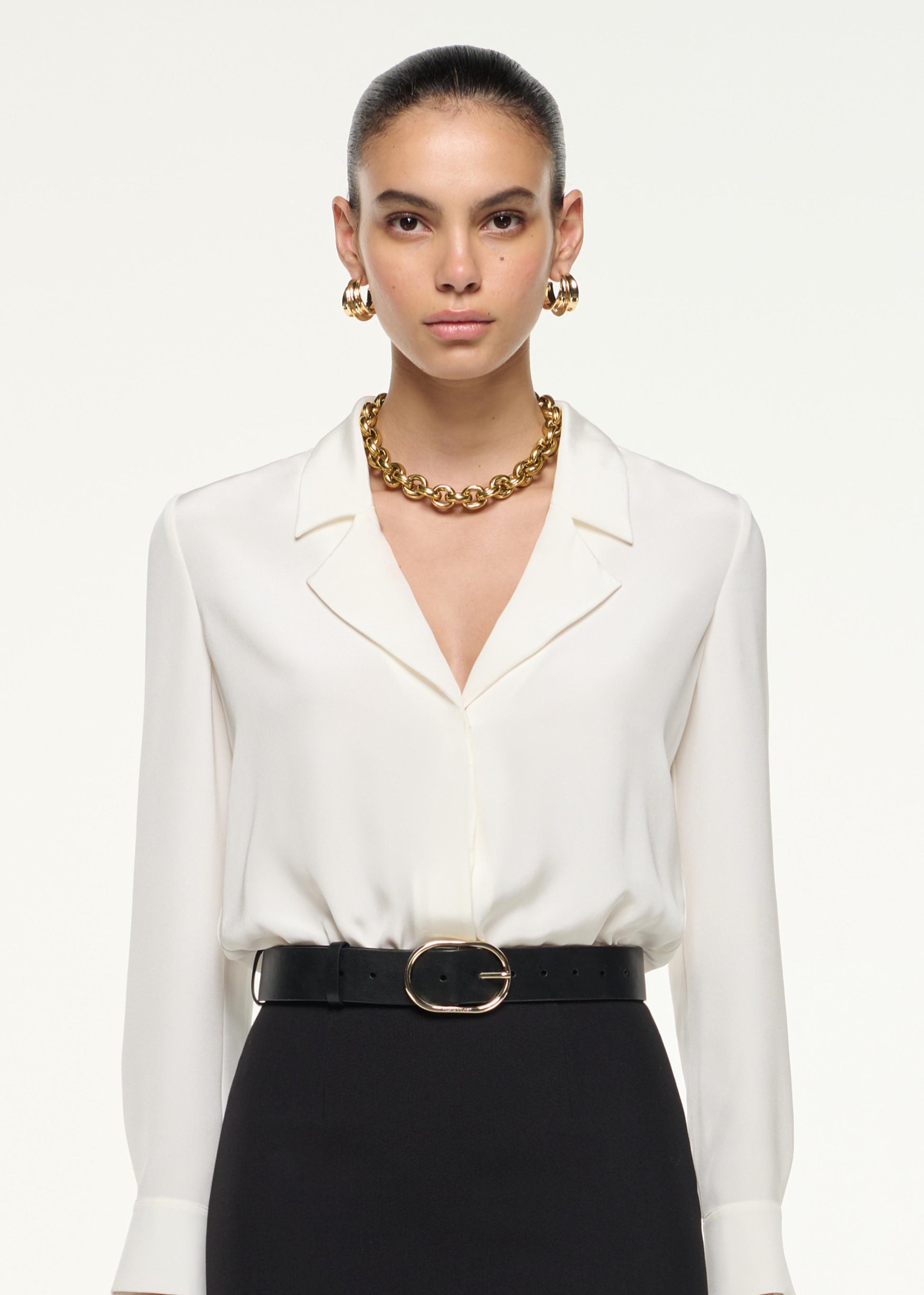 Close up of a model wearing the Silk Bodysuit in White