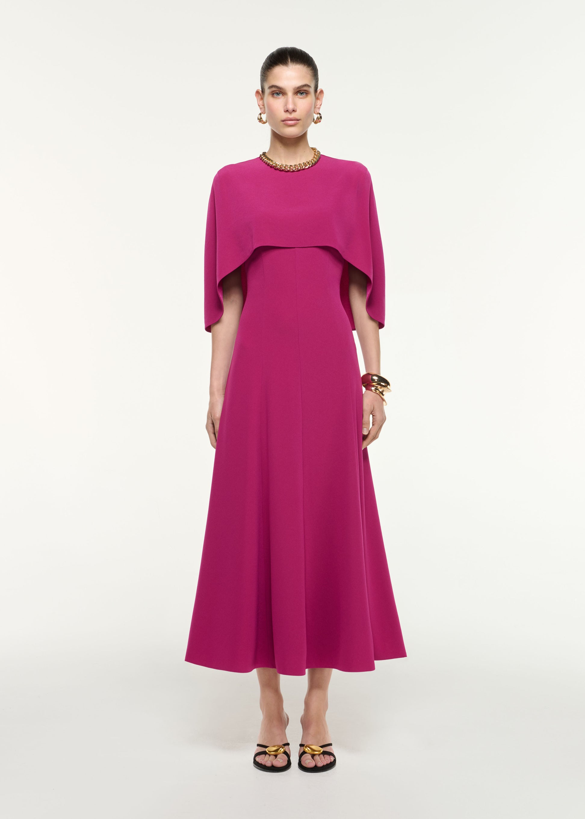 Front view of a model wearing the Satin Crepe Cape Midi Dress in Dark Pink