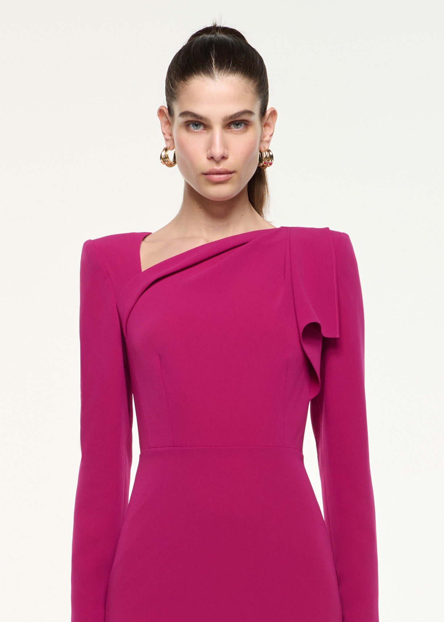Close up of a model wearing the Shoulder Drape Mini Dress in Dark Pink