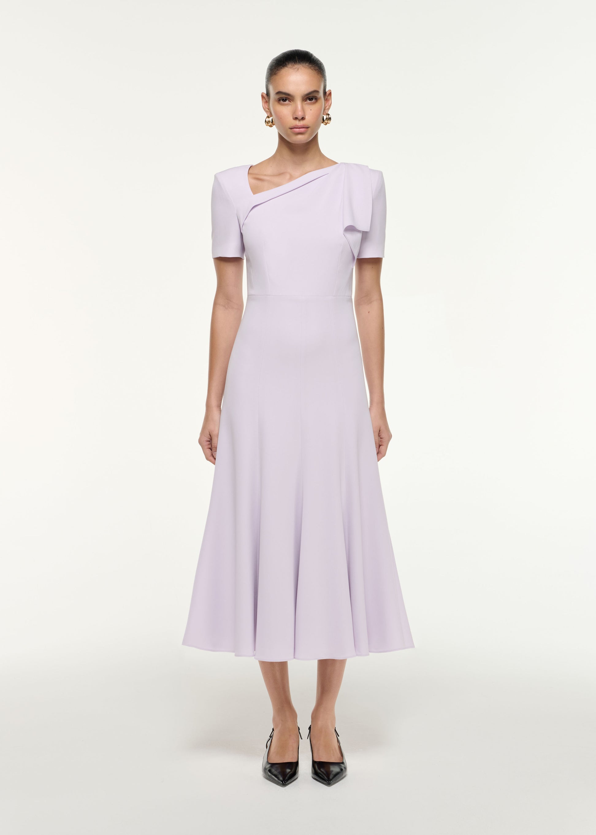 Front view of a model wearing the Shoulder Drape Midi Dress in Lilac