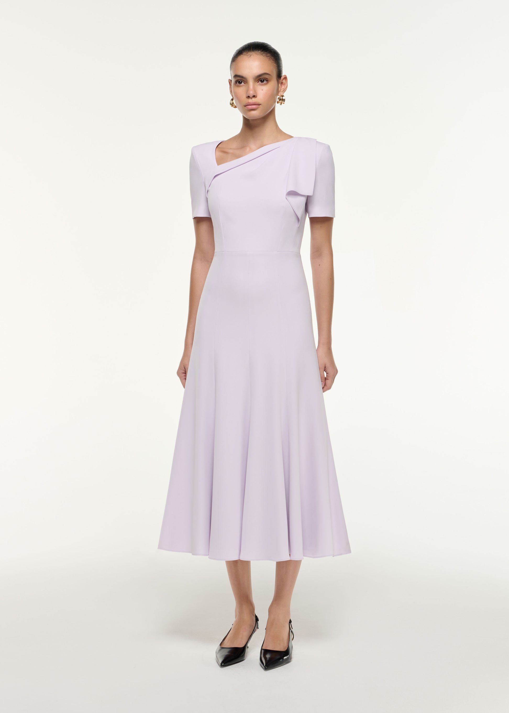 Side view of a model wearing the Shoulder Drape Midi Dress in Lilac