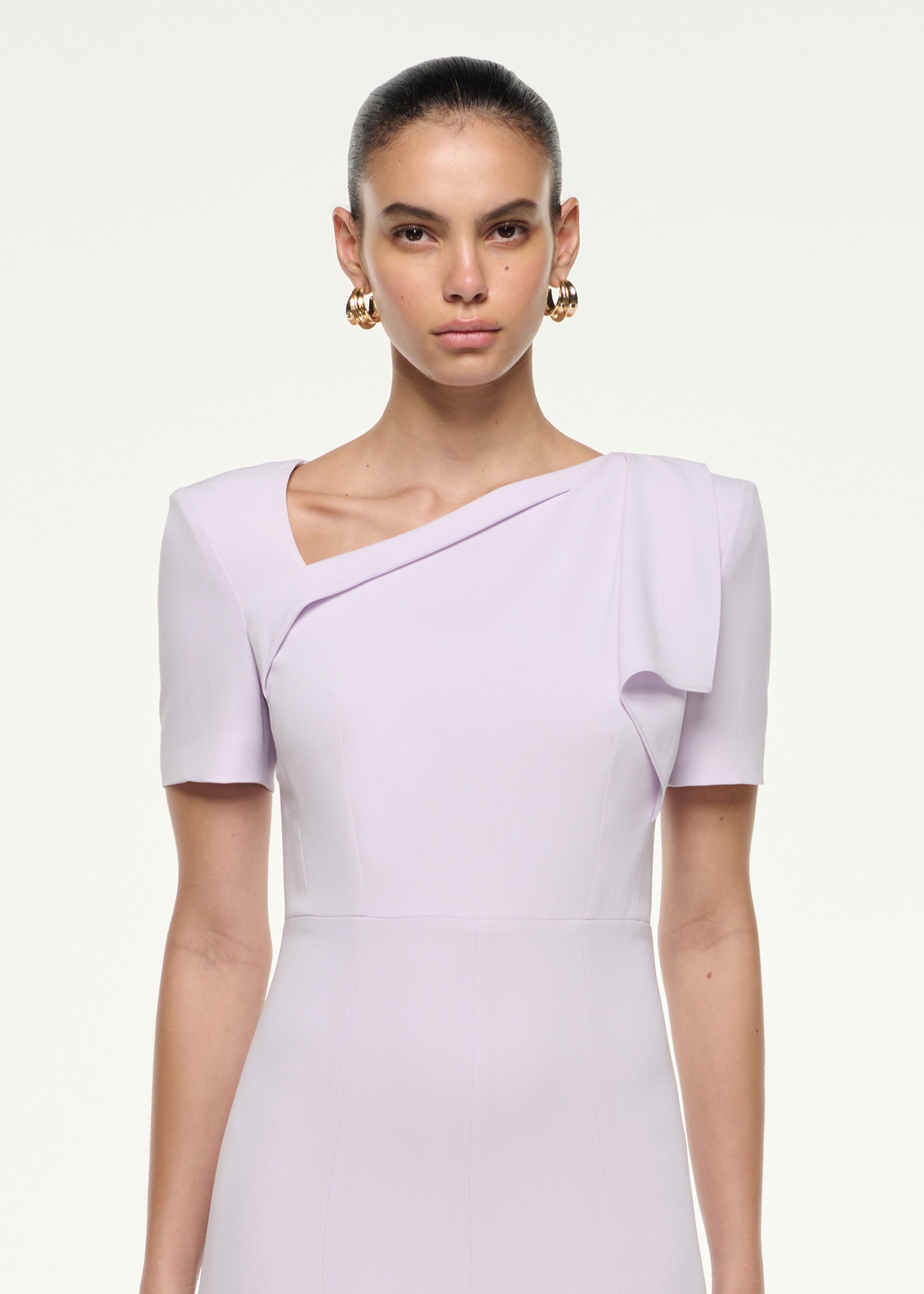 Close up of a model wearing the Shoulder Drape Midi Dress in Lilac