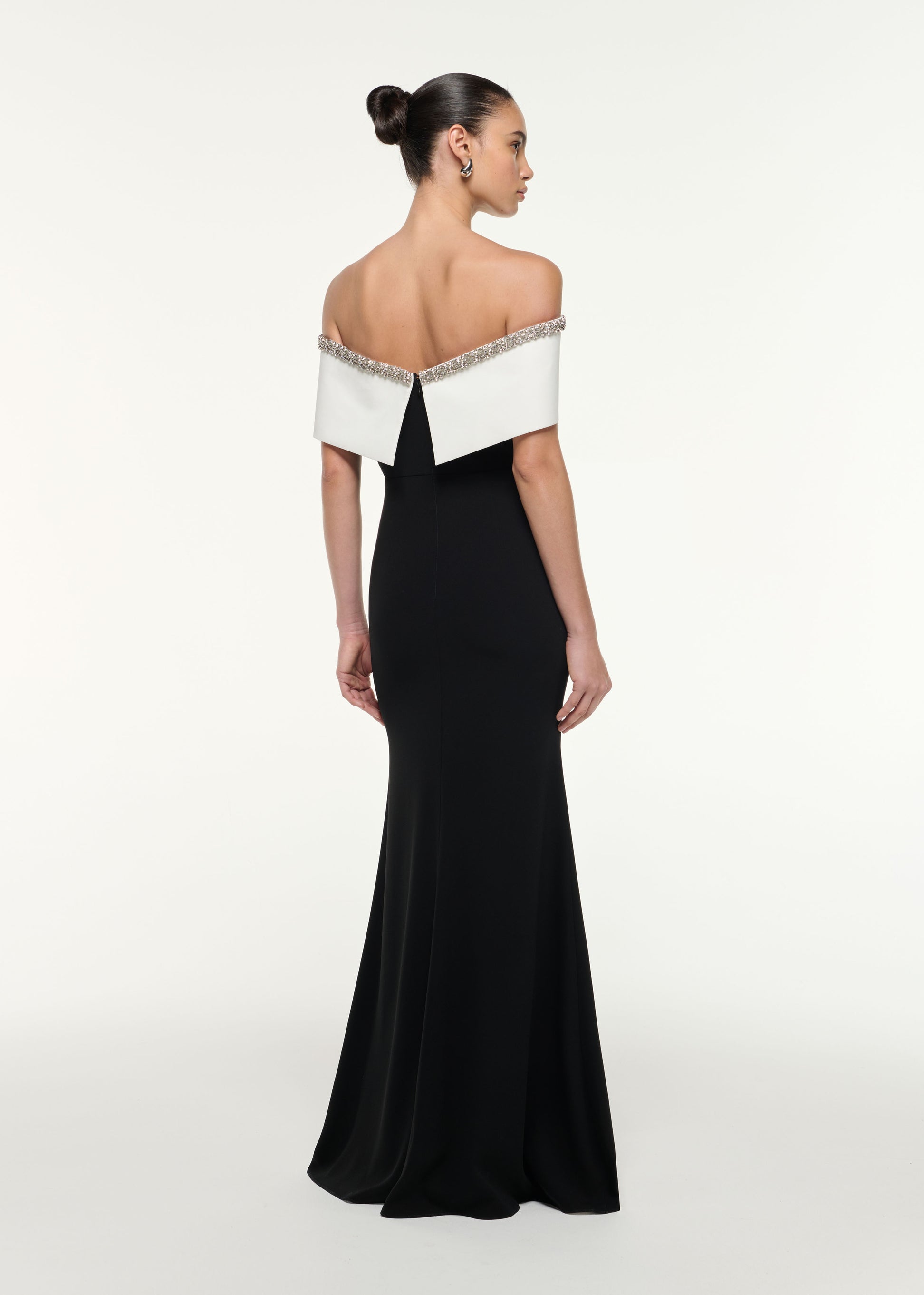 Back view of a model wearing the Off Shoulder Gown in Monochrome