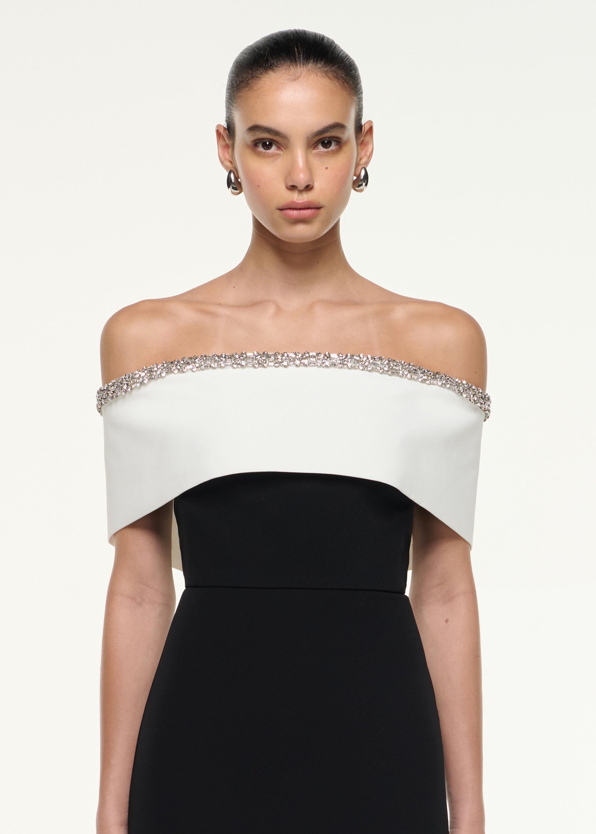 Close up of a model wearing the Off Shoulder Gown in Monochrome