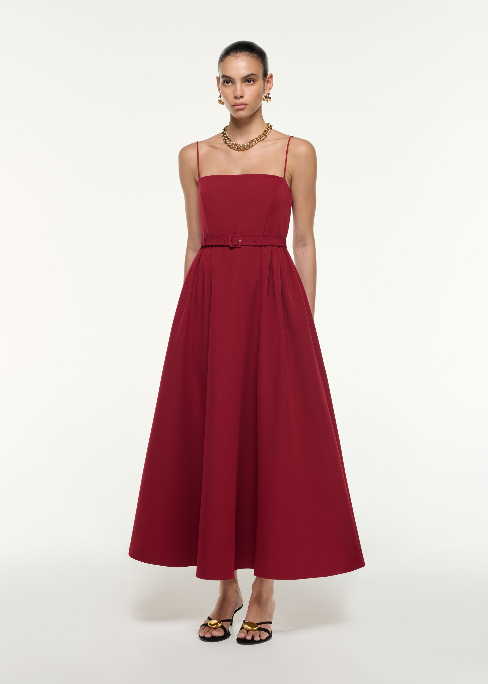 Side view of a model wearing the Belted Maxi Dress in Dark Red