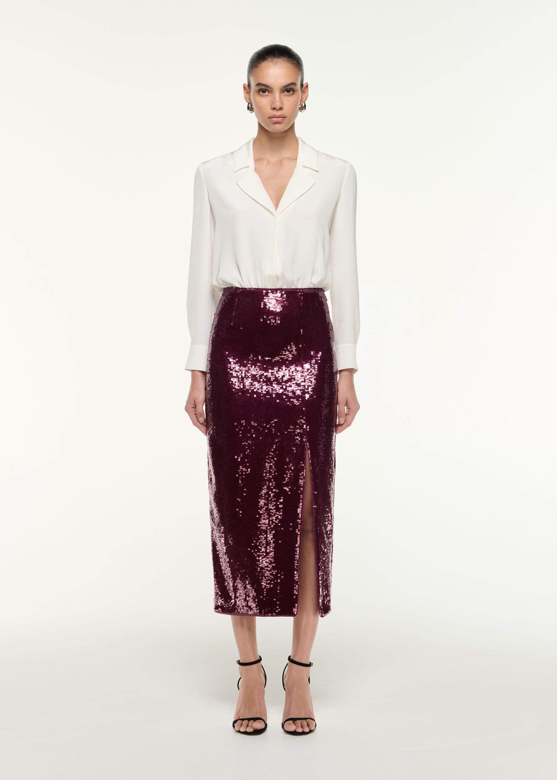 Front view of a model wearing the Sequin Midi Pencil Skirt in Dark Pink