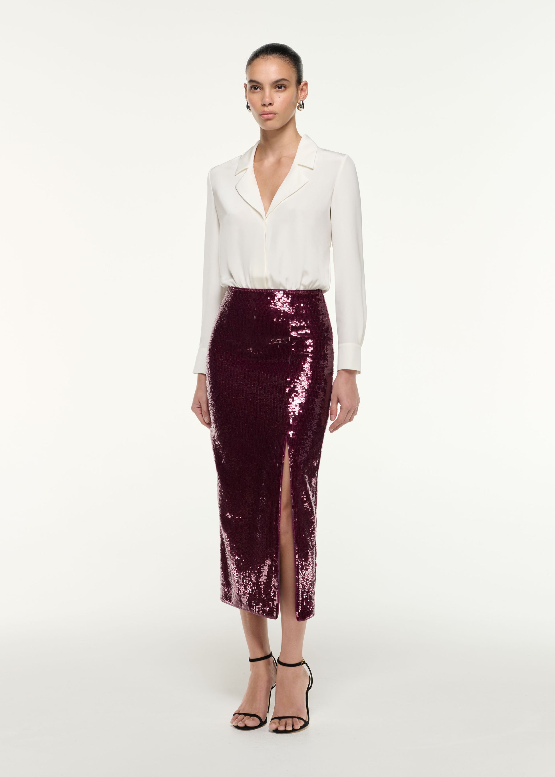 Side view of a model wearing the Sequin Midi Pencil Skirt in Dark Pink