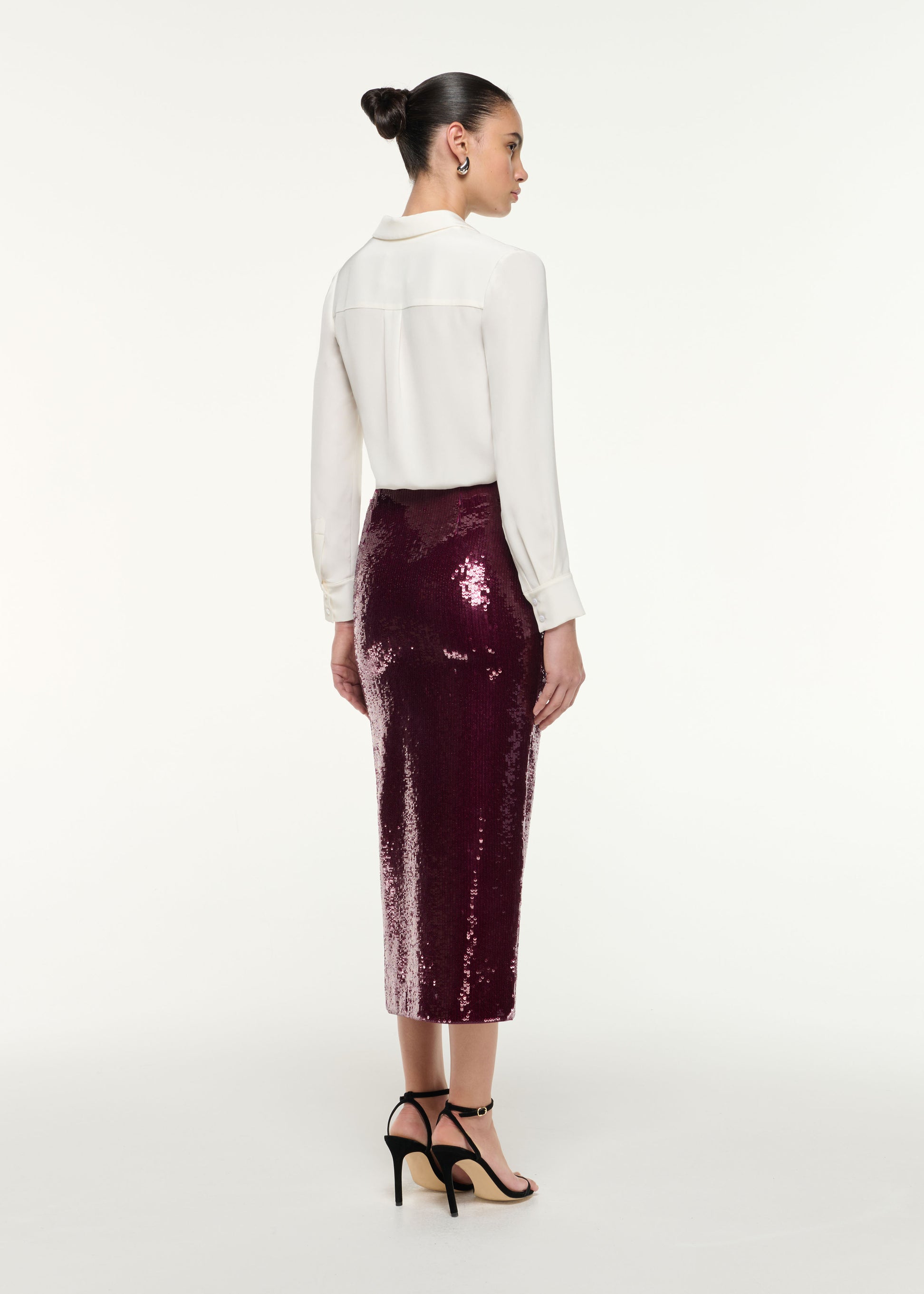Back view of a model wearing the Sequin Midi Pencil Skirt in Dark Pink