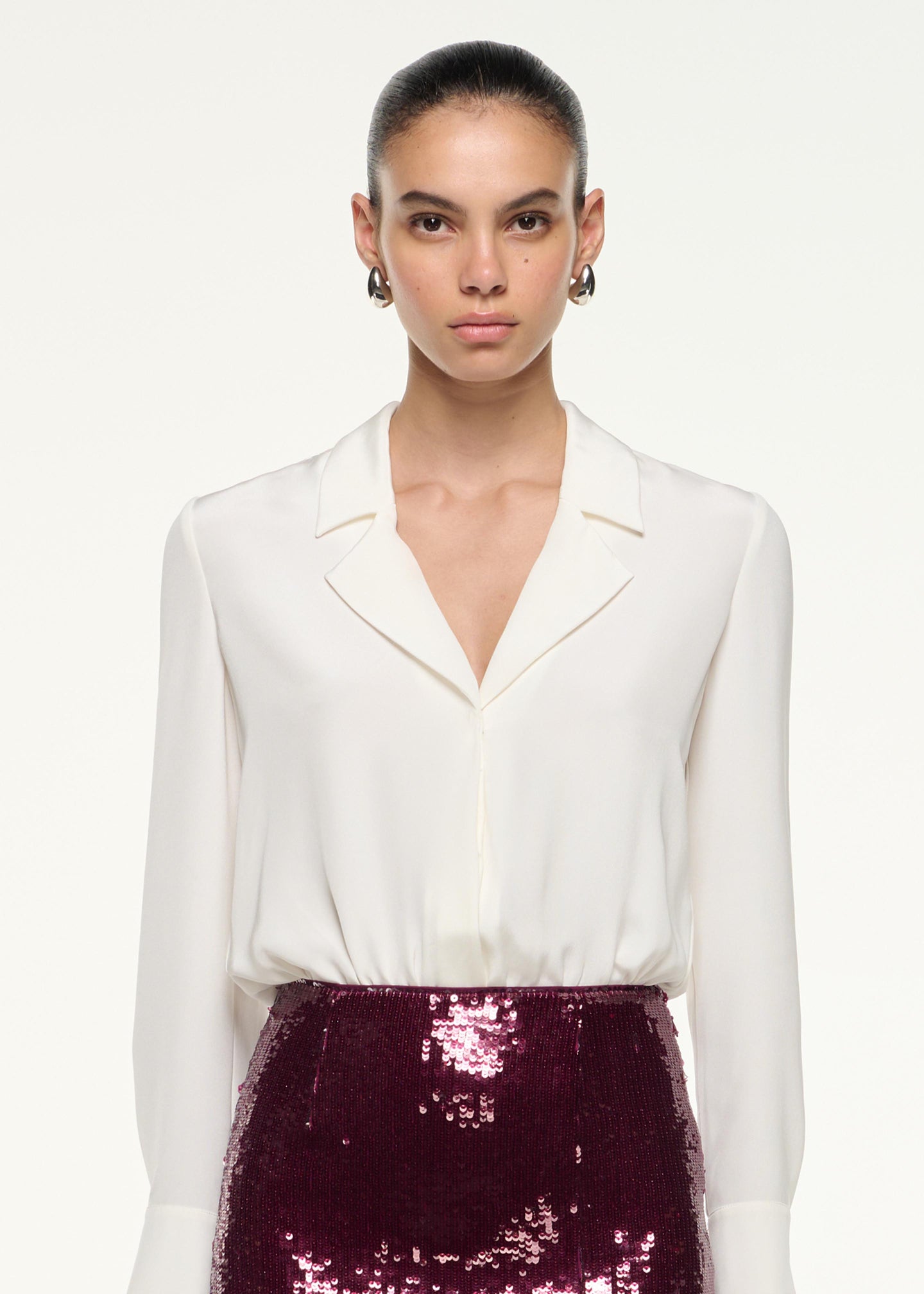 Close up of a model wearing the Sequin Midi Pencil Skirt in Dark Pink