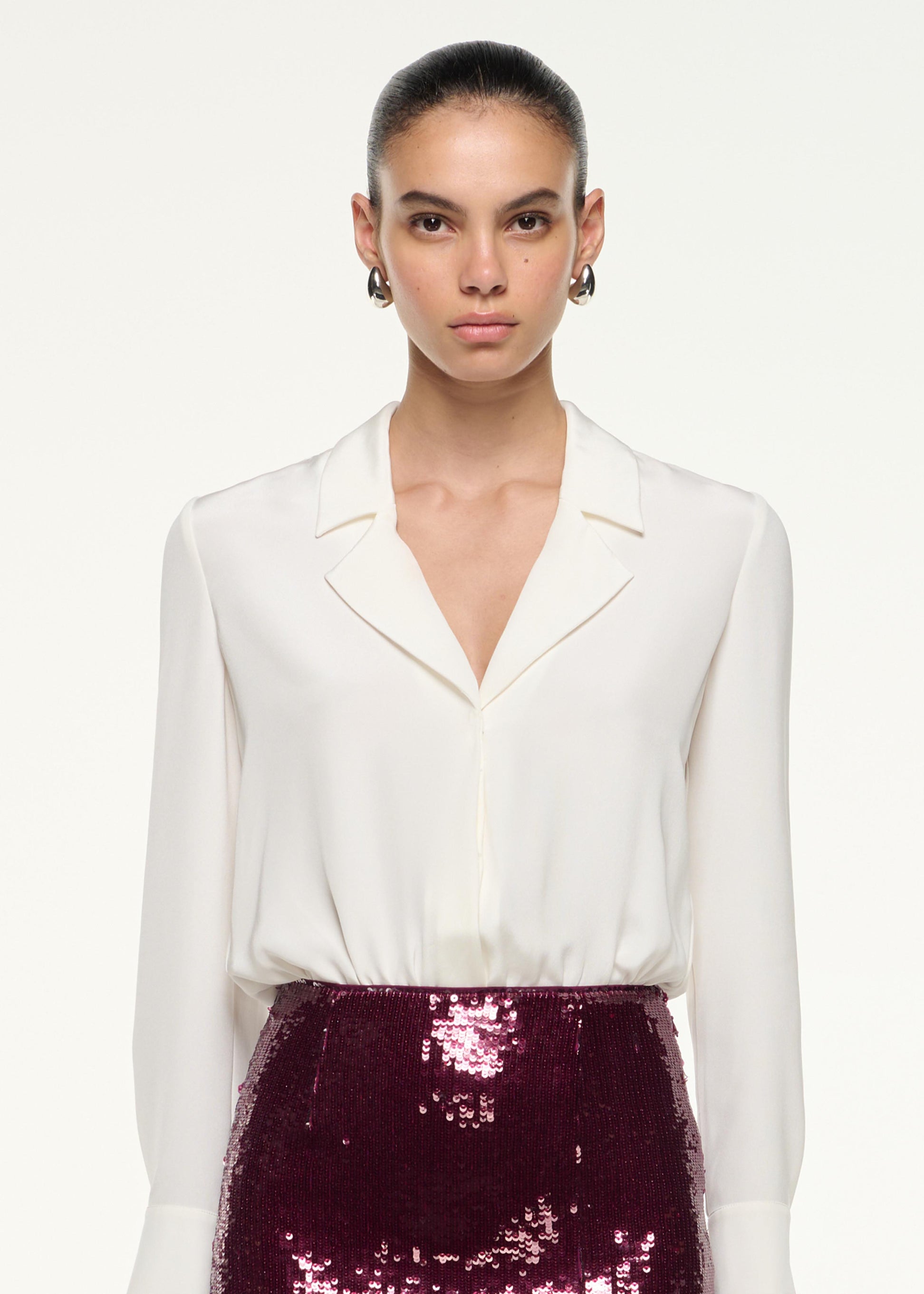 Close up of a model wearing the Sequin Midi Pencil Skirt in Dark Pink