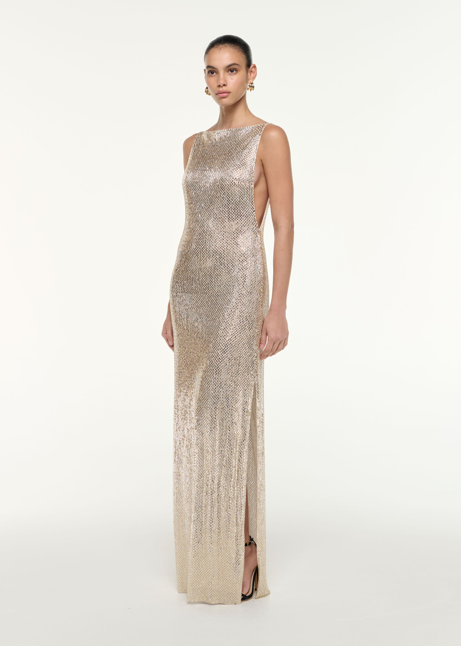 Side view of a model wearing the Mesh Diamante Gown in Champagne